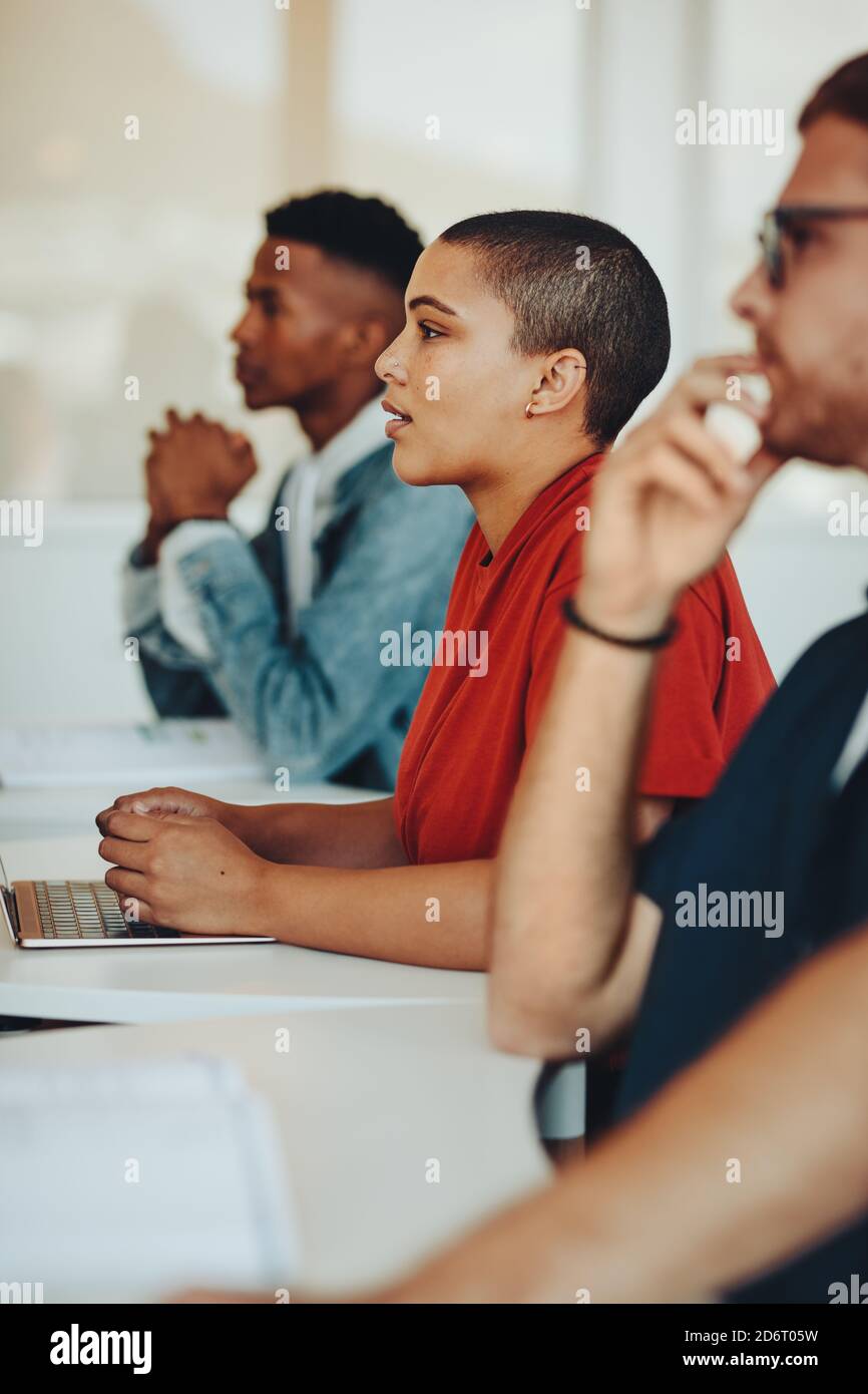 Teenage students paying attention to lecture in classroom. Students studying at the college classroom. Stock Photo