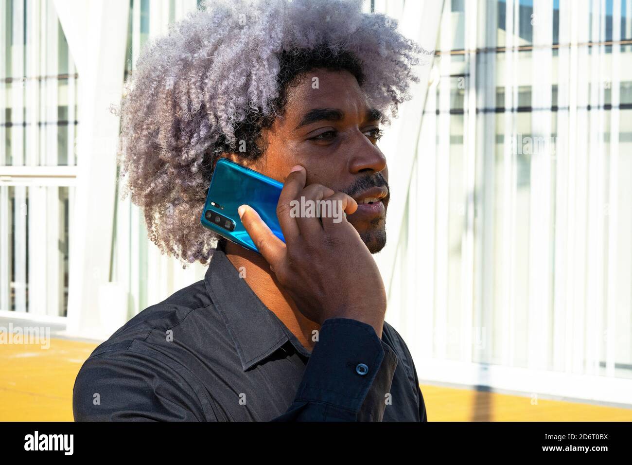 Afro black man talking on the phone in the city. Afro man concept. Making a phone call. Stock Photo