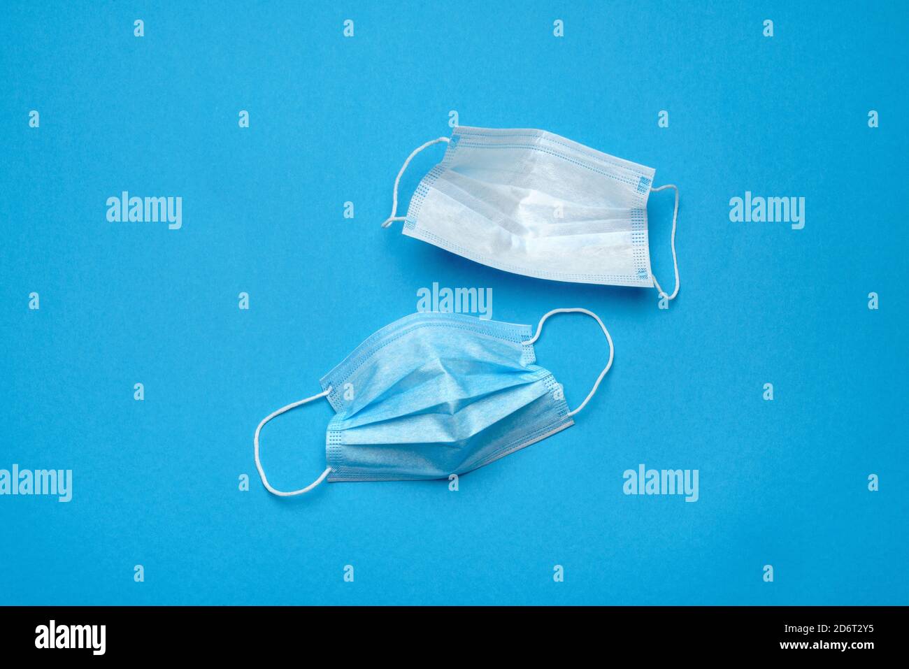 Disposable blue medical face masks on blue background Stock Photo - Alamy