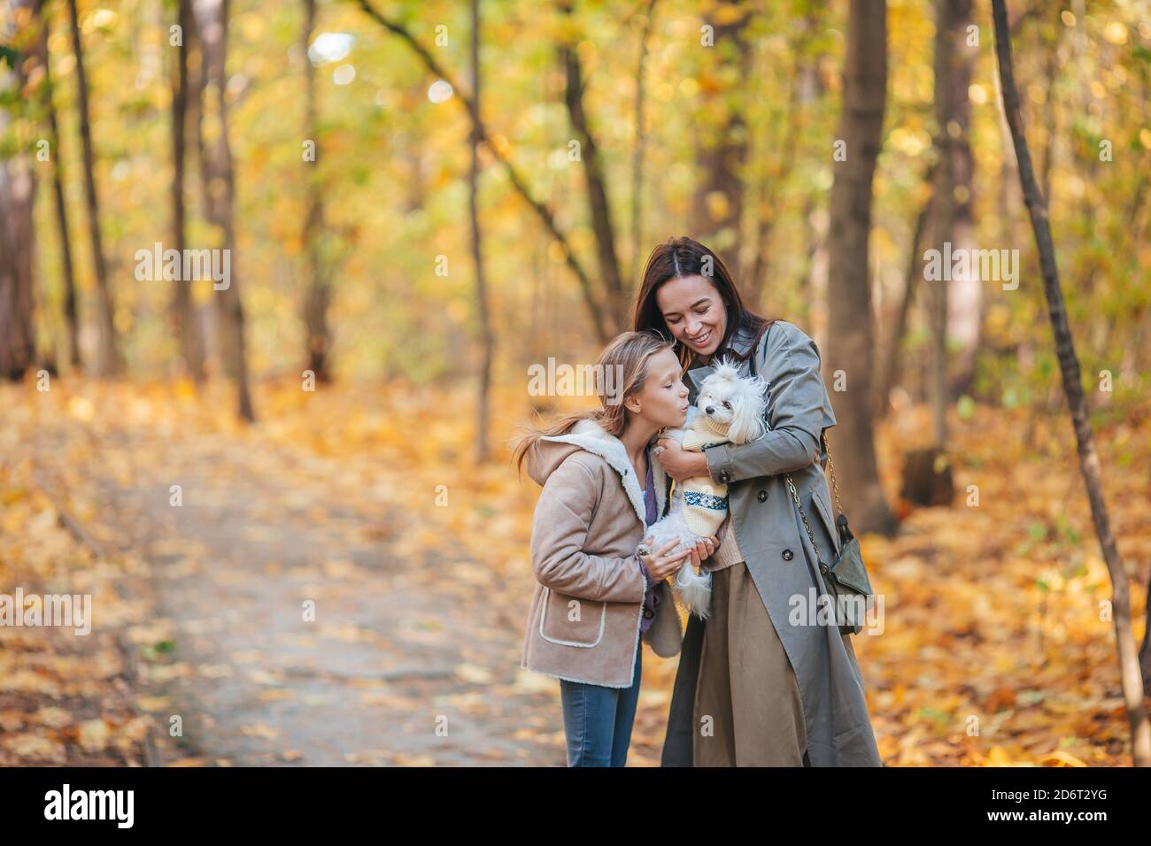 Little girl with mom outdoors in park at autumn day Stock Photo - Alamy