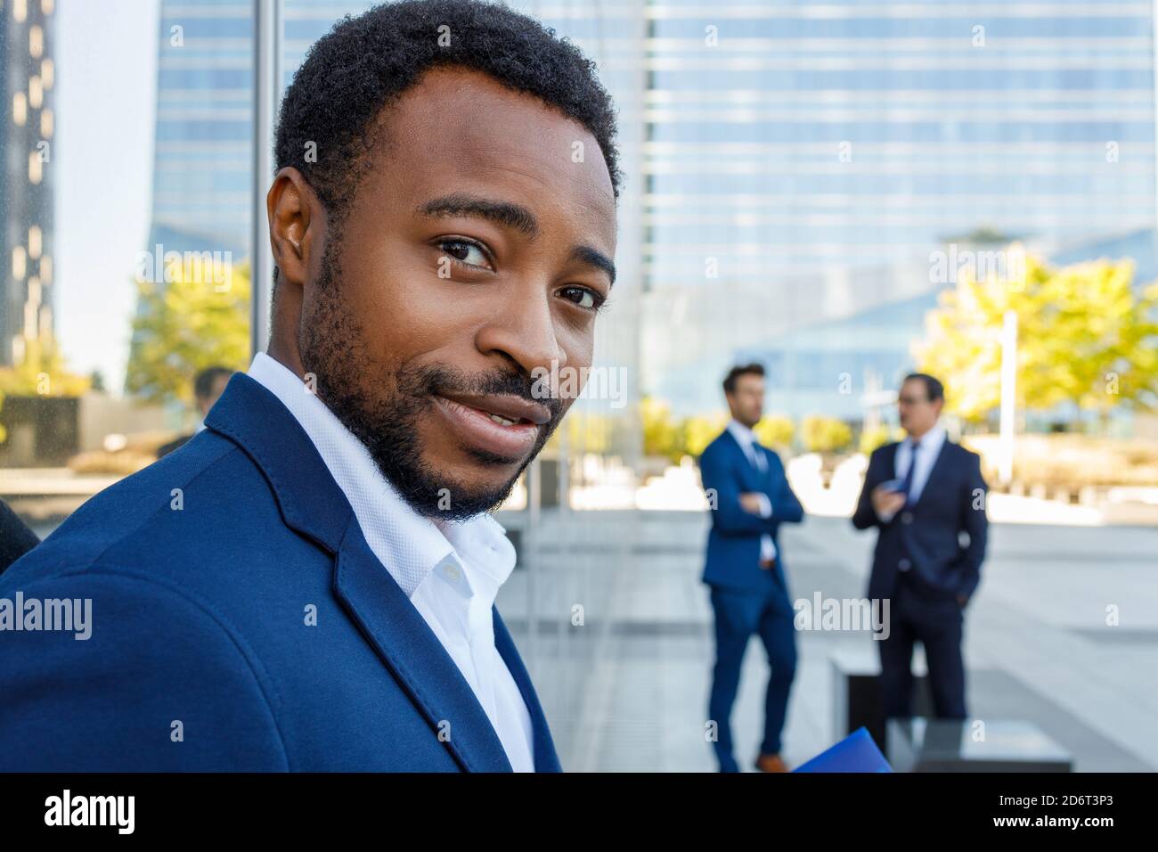 Side view of optimistic young African American businessman in formal ...