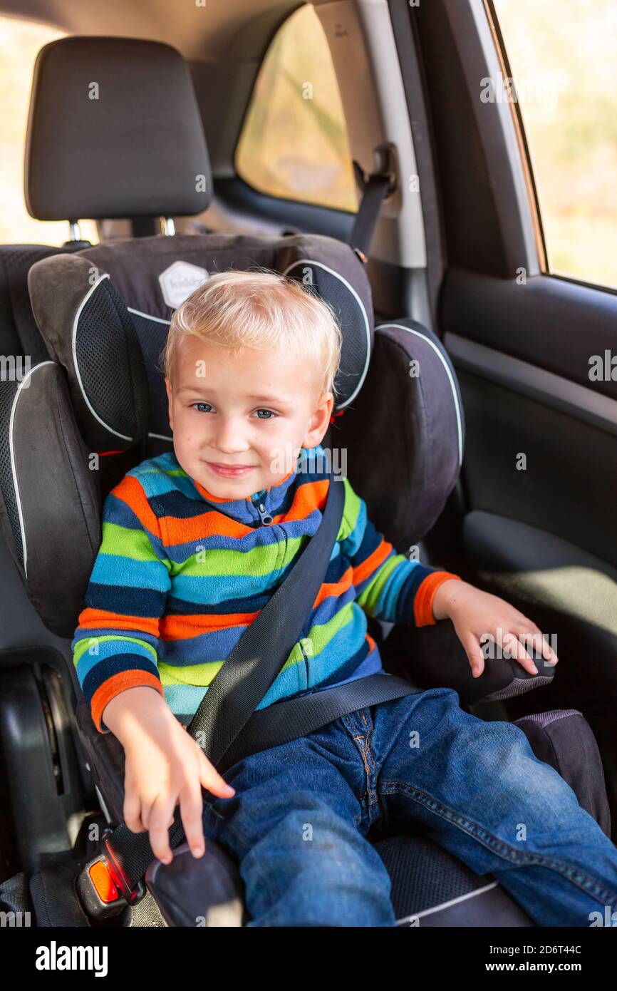 Little Baby Boy Sitting On A Car Seat Buckled Up In The Car Children s