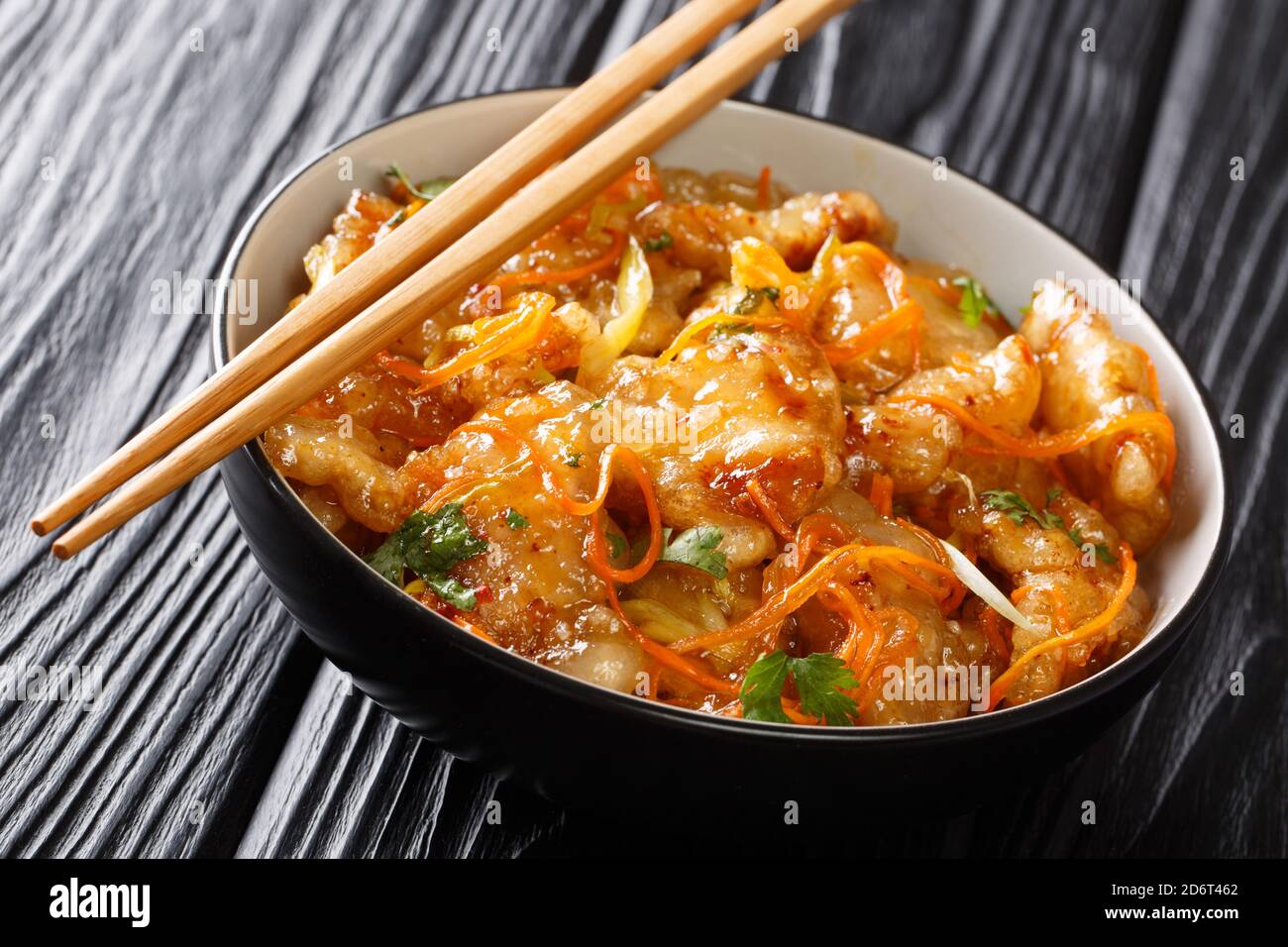 Crispy tasty Guo Bao Rou is a classic dish from Northeast China made with pork in a sweet and sour sauce closeup. Horizontal Stock Photo