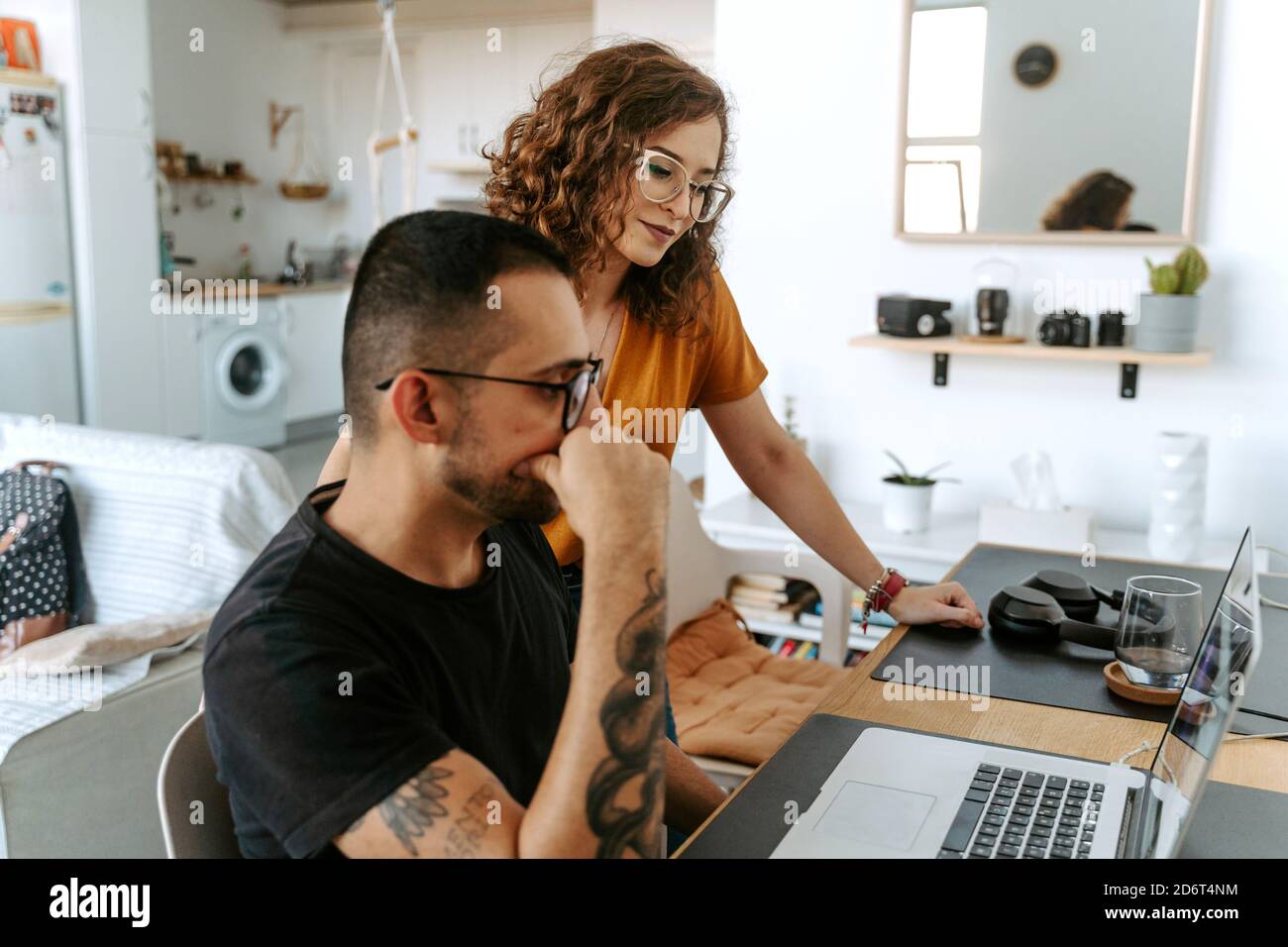Side view of young bearded ethnic man and curly haired Woman in casual