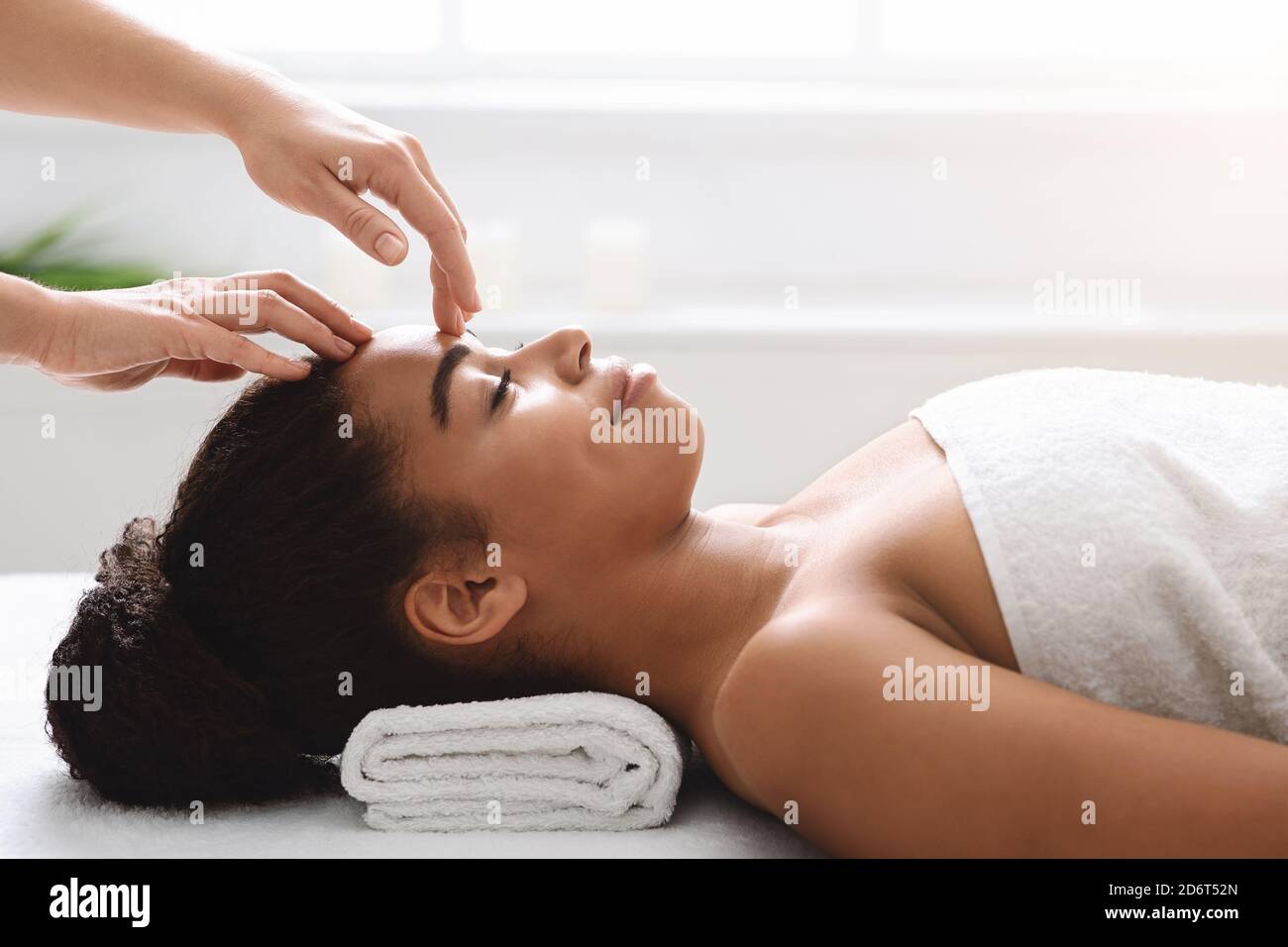 Spa therapist making relaxing head massage for young beautiful lady Stock  Photo - Alamy