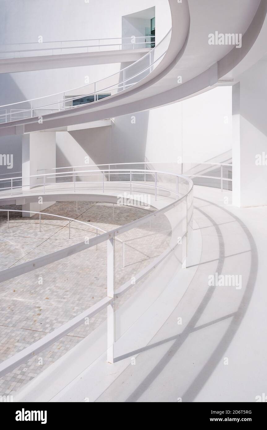 White smooth ramps or inclines with railings located outside modern ...
