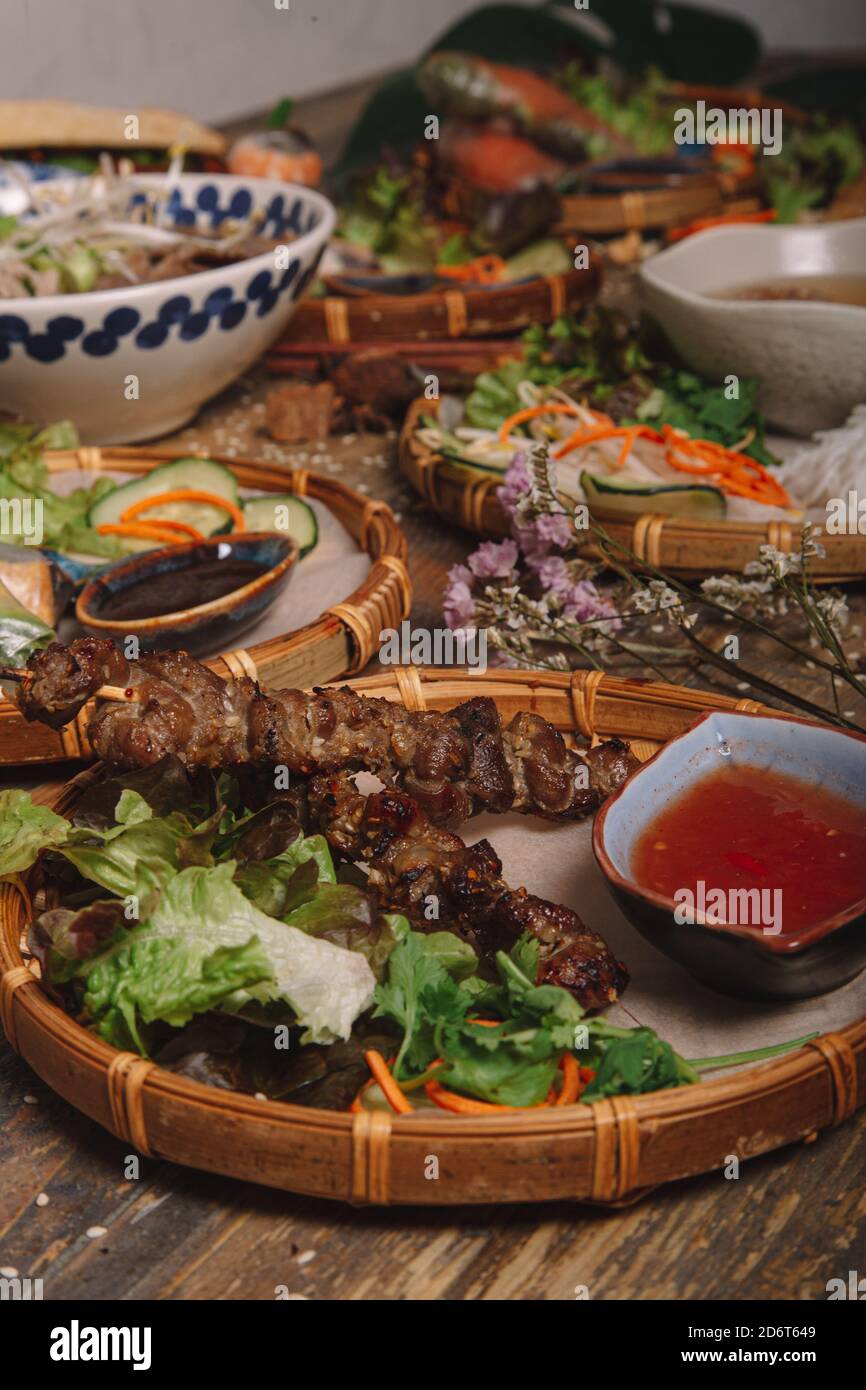 From above of assorted dishes of Vietnamese cuisine arranged on wooden