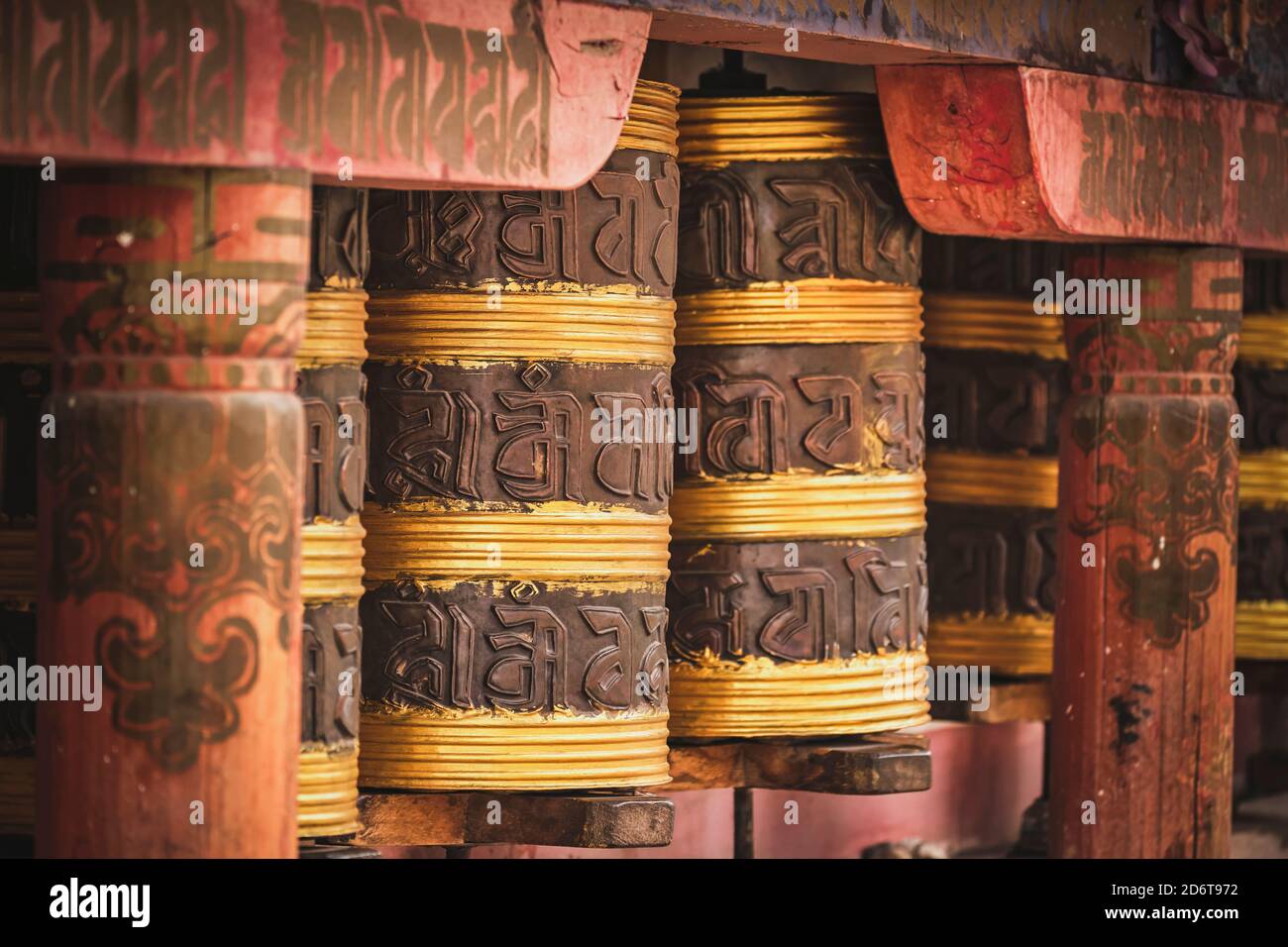 Exterior of Tibetan church decorated with big cylindrical rolls with