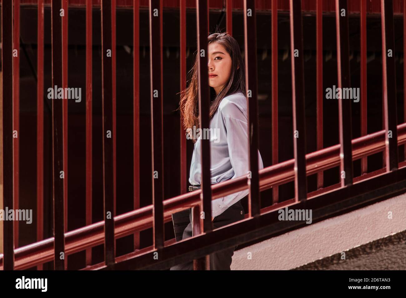 Side view of young attentive Woman with long dark hair in classy outfit
