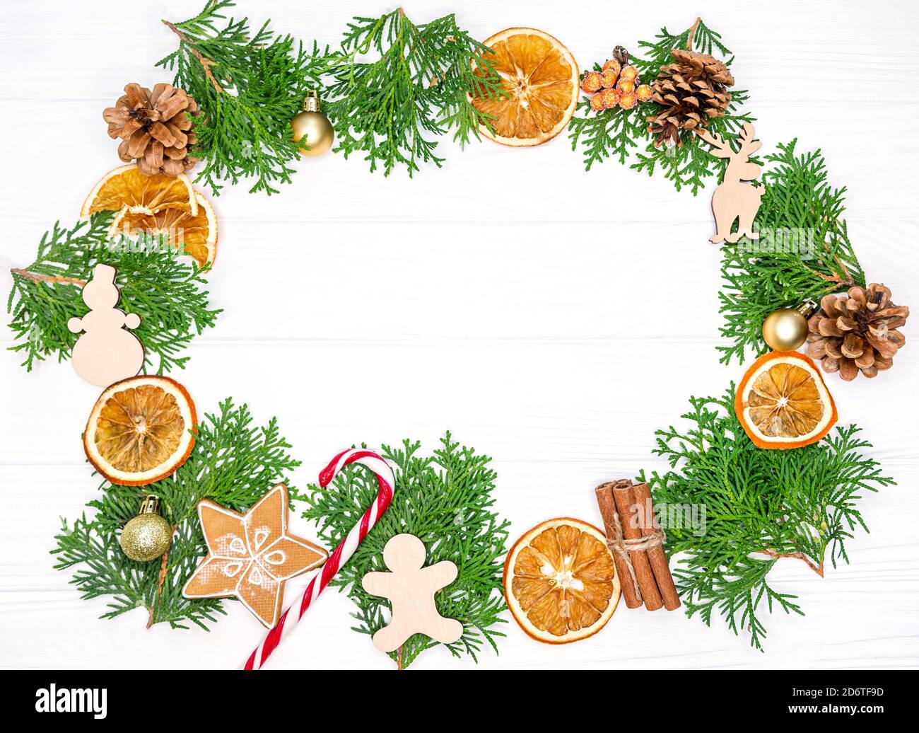 Christmas frame with fir tree branches, oranges, gingerbread cookies Stock Photo