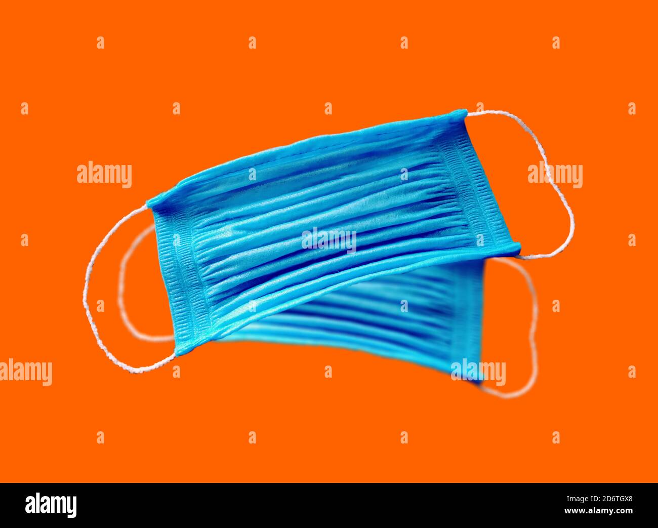 blue medical masks on an orange background. View from above Stock Photo