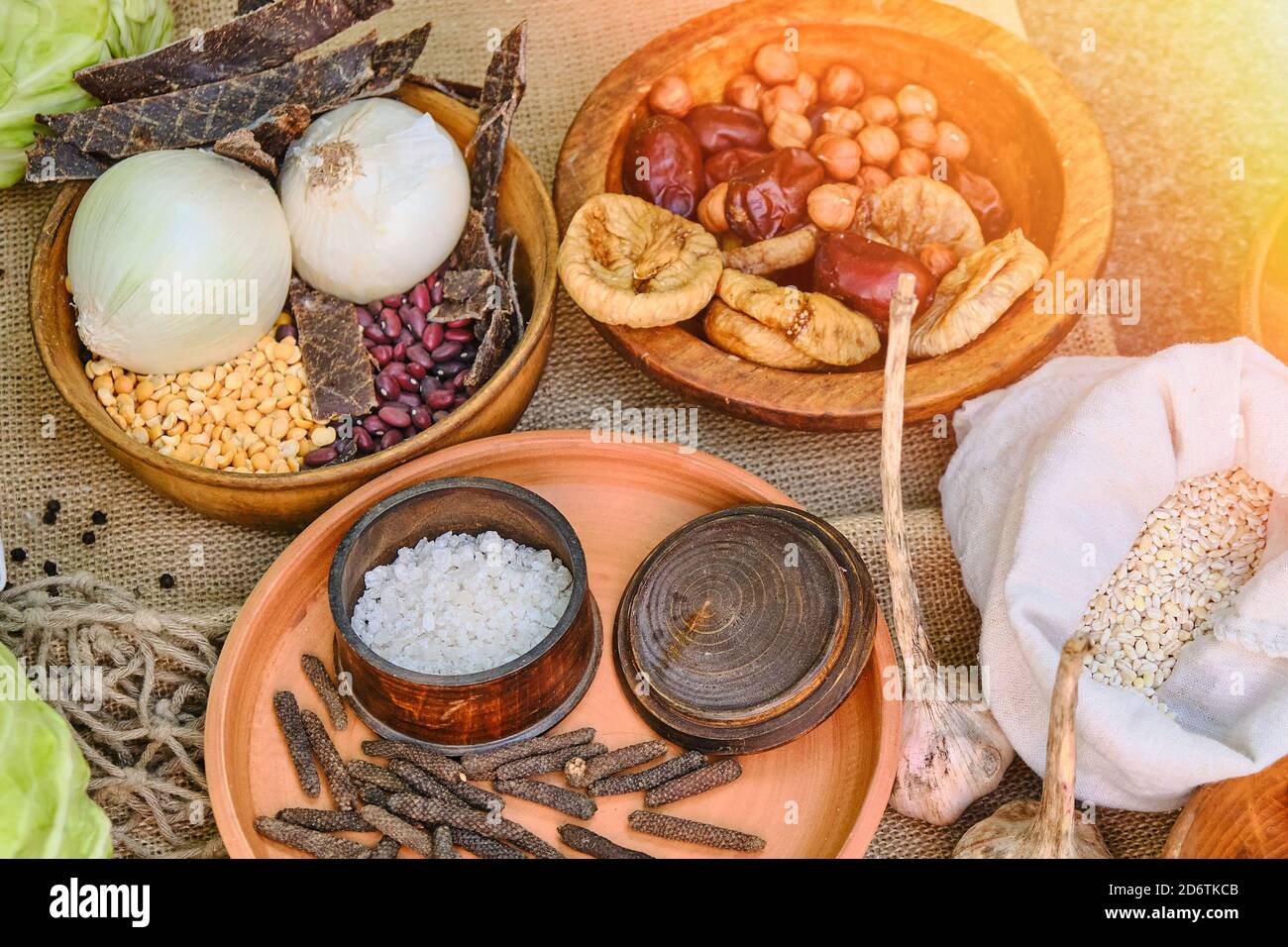 Food soldiers of the ancient Romans on the table, reconstruction. Salt, cereals, beans, dried fruits, garlic and cabbage. Food warriors on a hike in t Stock Photo