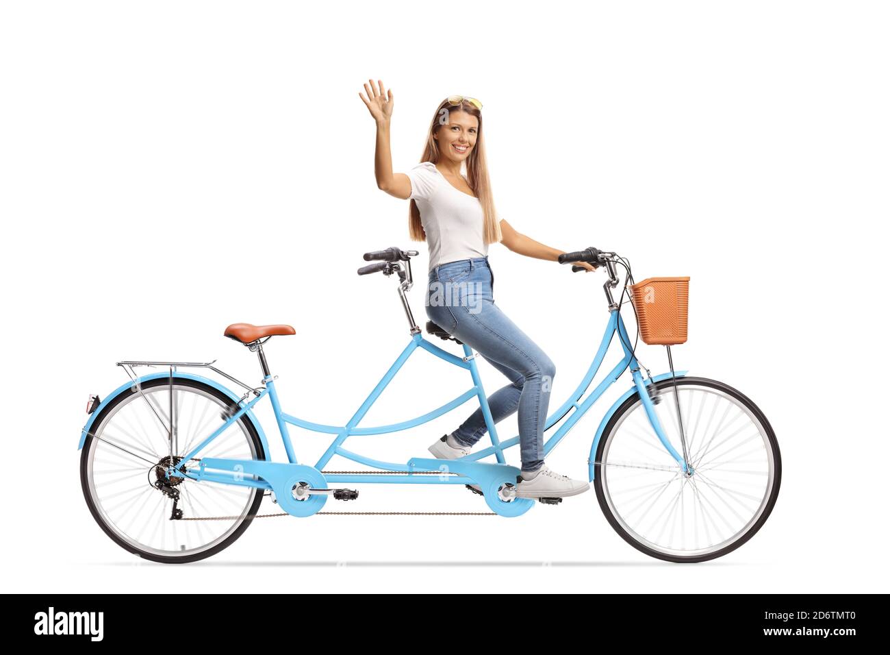 Young woman in casual clothes riding a tandem bicycle and waving isolated on white background