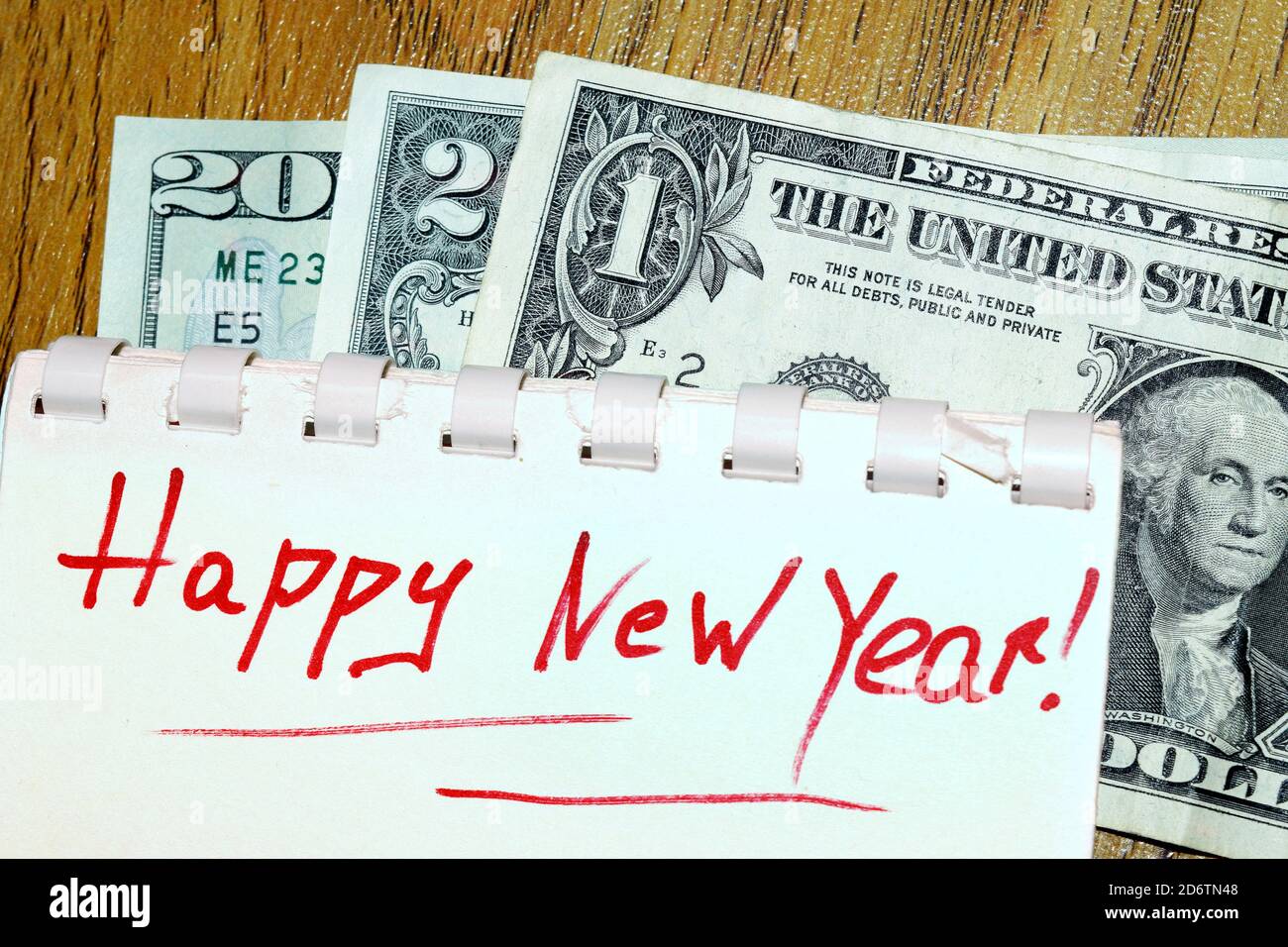 greeting card with a Happy New Year 2021 laid out with one dollar, two dollar, and 20 dollar bills Stock Photo