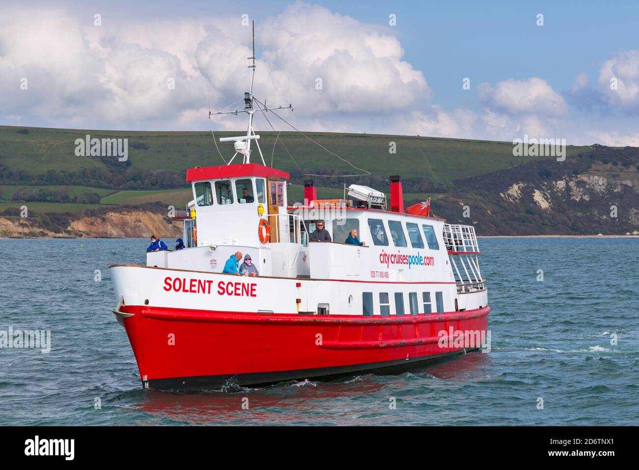 Passengers enjoy a trip along the coastline and around the bay on the Solent Scene boat arriving in Swanage, Dorset UK in October Stock Photo