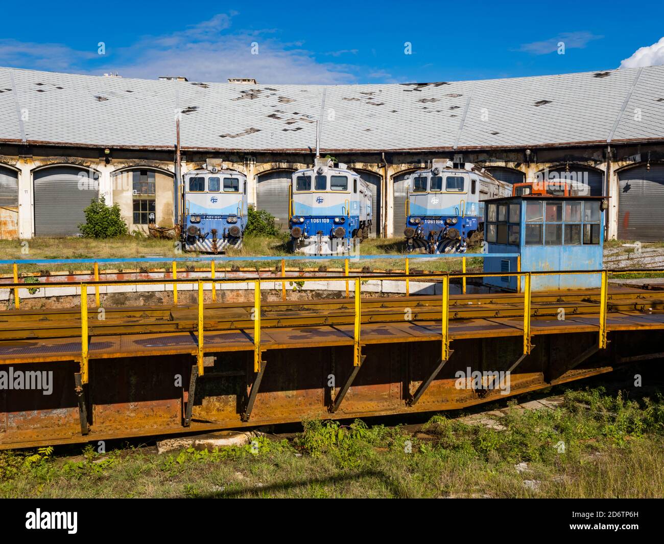 Locomotives HZ series 1061 012, 109 and 106 (ex series 362) built by Ansaldo-Breda now standing derelict behind metal framework in Rijeka in Croatia Stock Photo