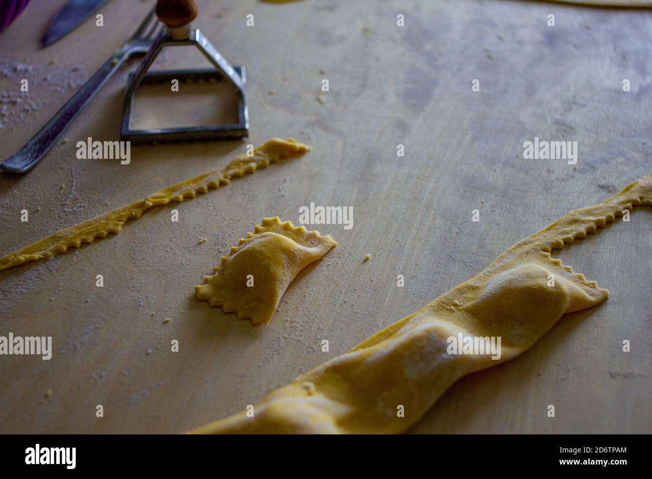 The preparation of tortelli with pasta. Typical dish of Emilian - Italian cuisine. Stock Photo
