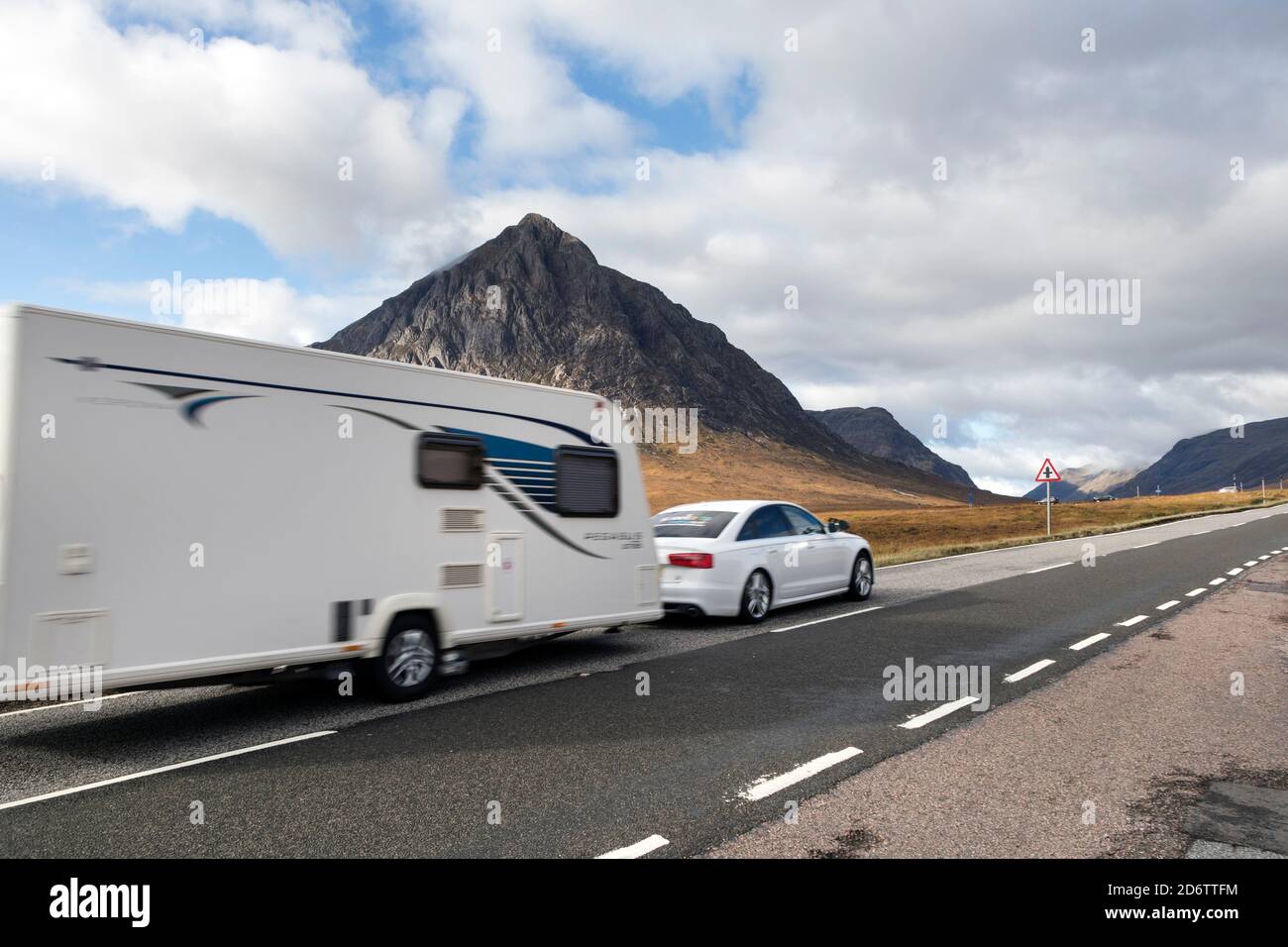 Traffic on the A82 Road with the Mountain of Buachaille Etive Mor as a Backdrop, Glencoe, Highland, Scotland, UK Stock Photo