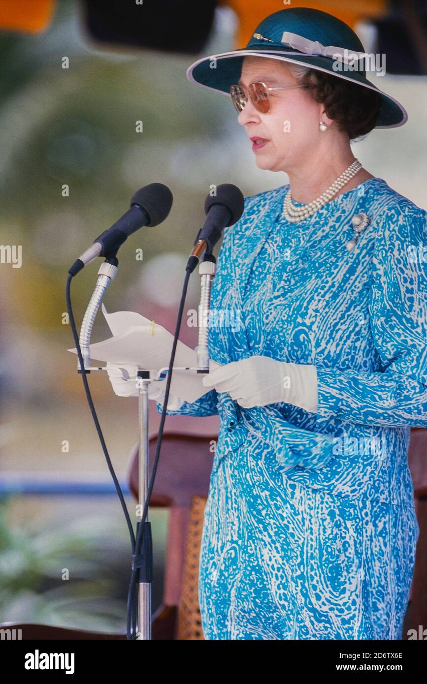 Queen Elizabeth II giving a speech at a visit to Queen's College to officiate at a stone laying ceremony for the new school building. Barbados, Caribbean. 1989 Stock Photo