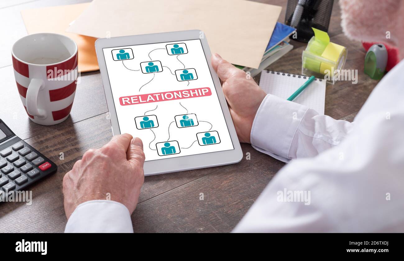 Relationship concept shown on a tablet held by a man Stock Photo