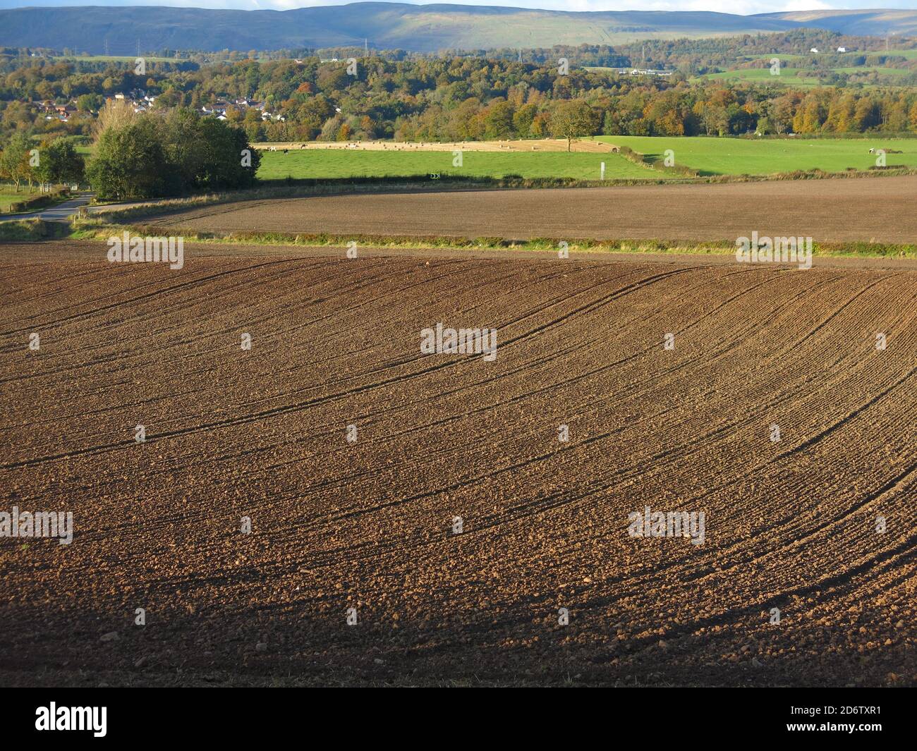 Looking north towards the Campsie Fells across ploughed fields in early autumn; the countryside of Central Scotland just outside Bearsden, Glasgow. Stock Photo