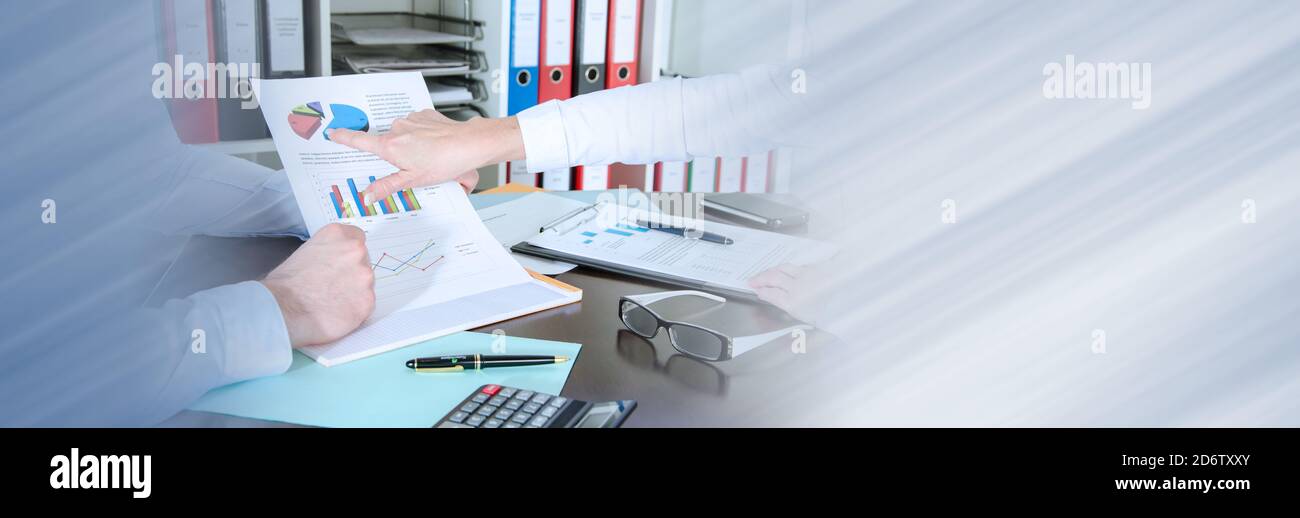 Two business people analyzing charts; panoramic banner Stock Photo - Alamy