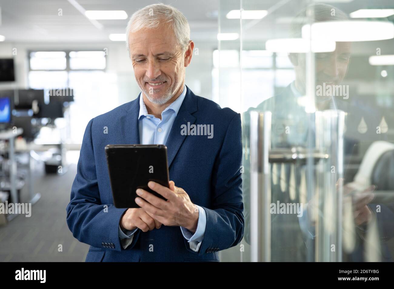 Senior businessman using digital tablet at modern office Stock Photo