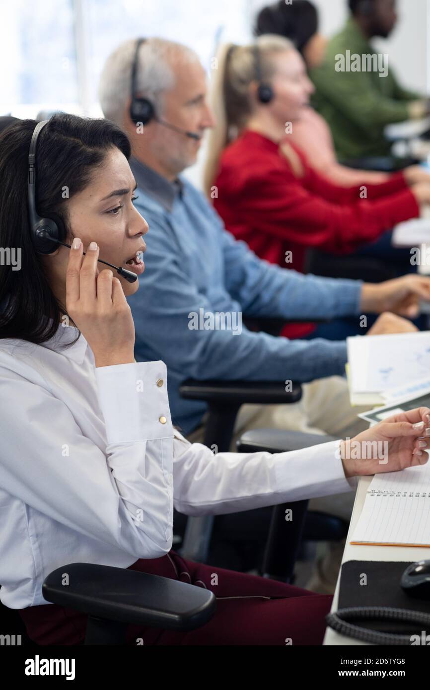 Businesswoman wearing headset working at office Stock Photo
