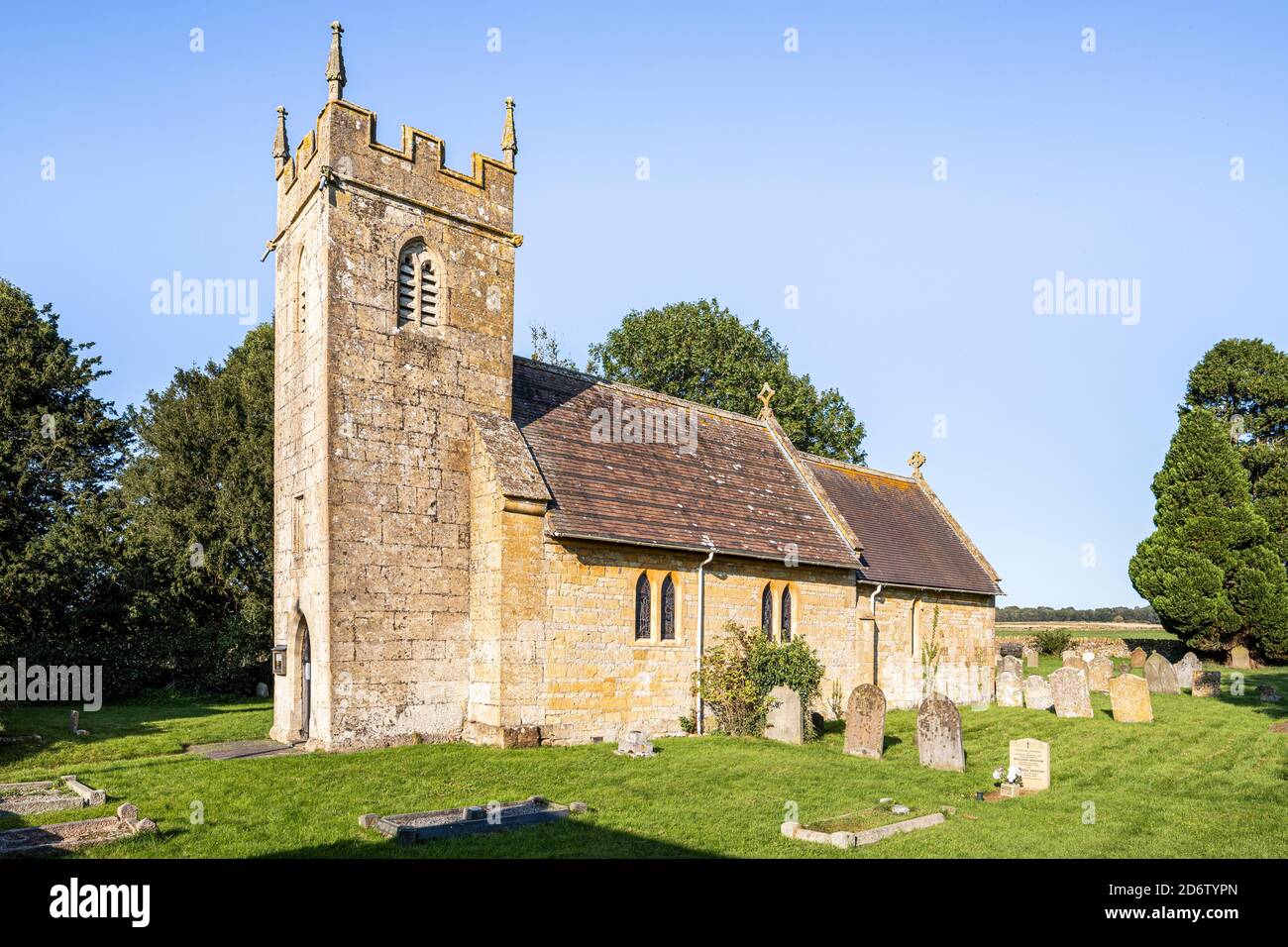 Evening light on the church of St James in the Cotswold village of Cutsdean, Gloucestershire UK - The tower is probably 14th century. Stock Photo