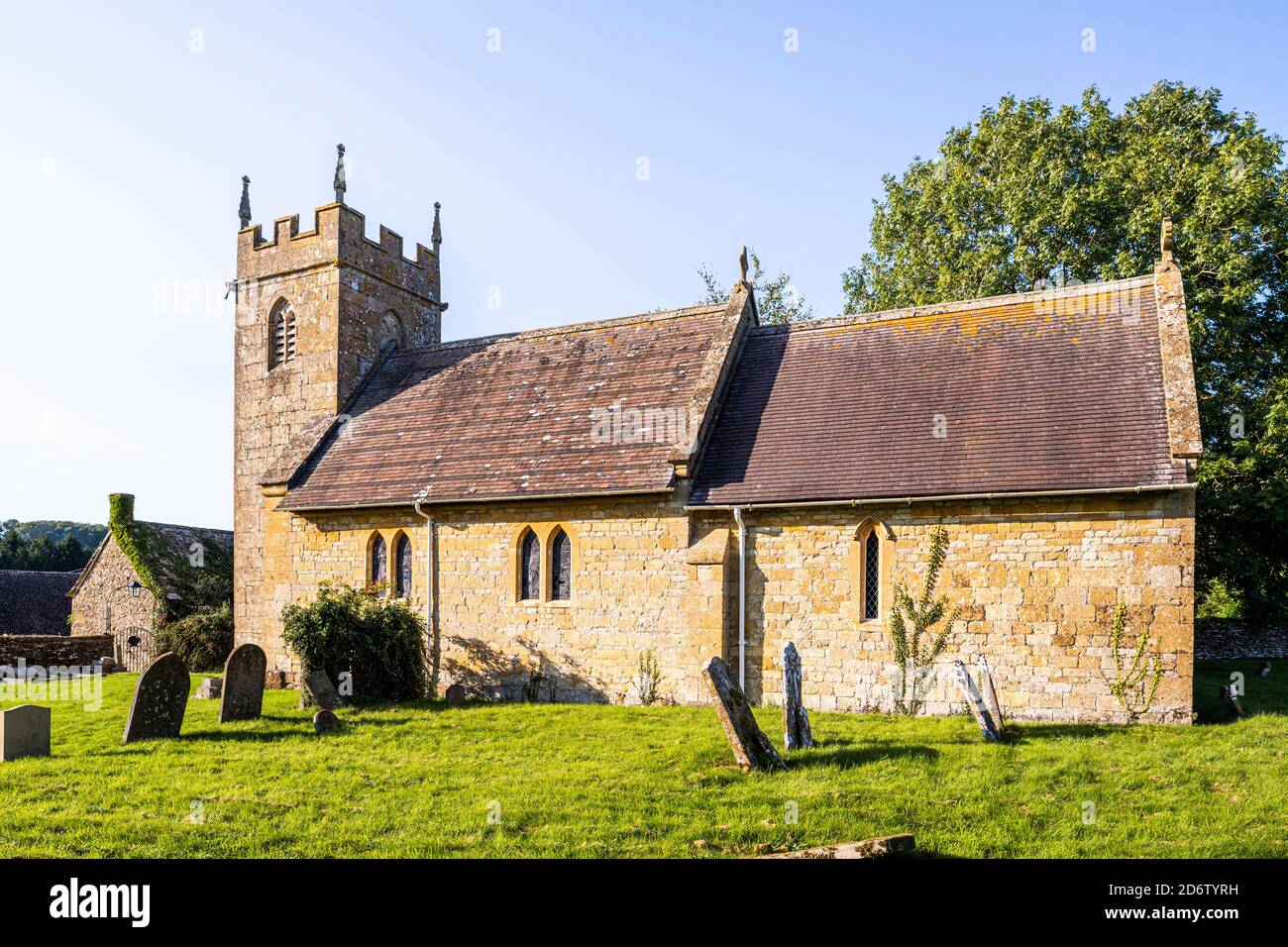 Evening light on the church of St James in the Cotswold village of Cutsdean, Gloucestershire UK - The tower is probably 14th century. Stock Photo
