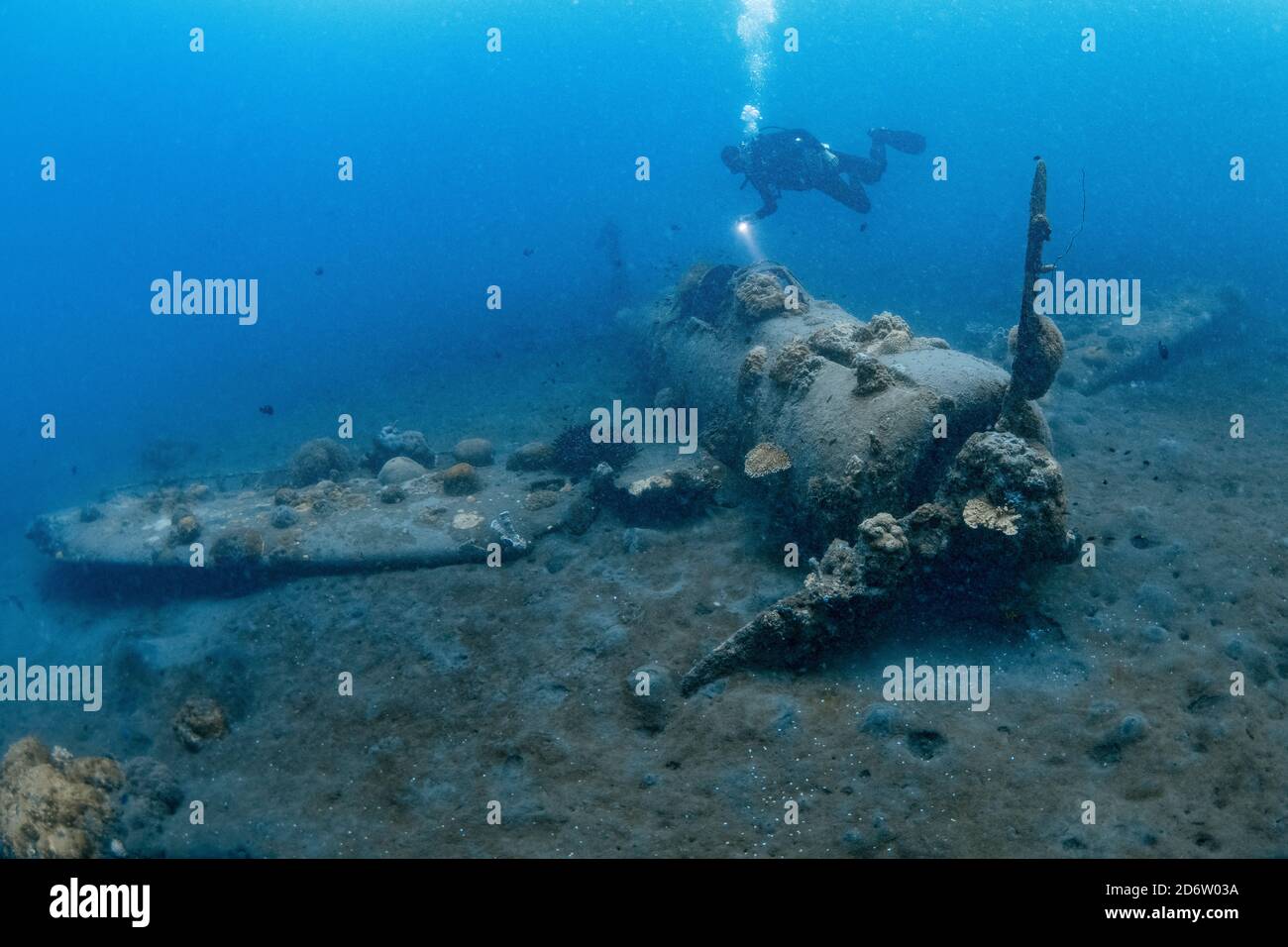 A diver investigates a Japanese Zero fighter plane that ditched in shallow water. Kimbe Bay, New Britain, Papua New Guinea, Pacific Ocean Stock Photo