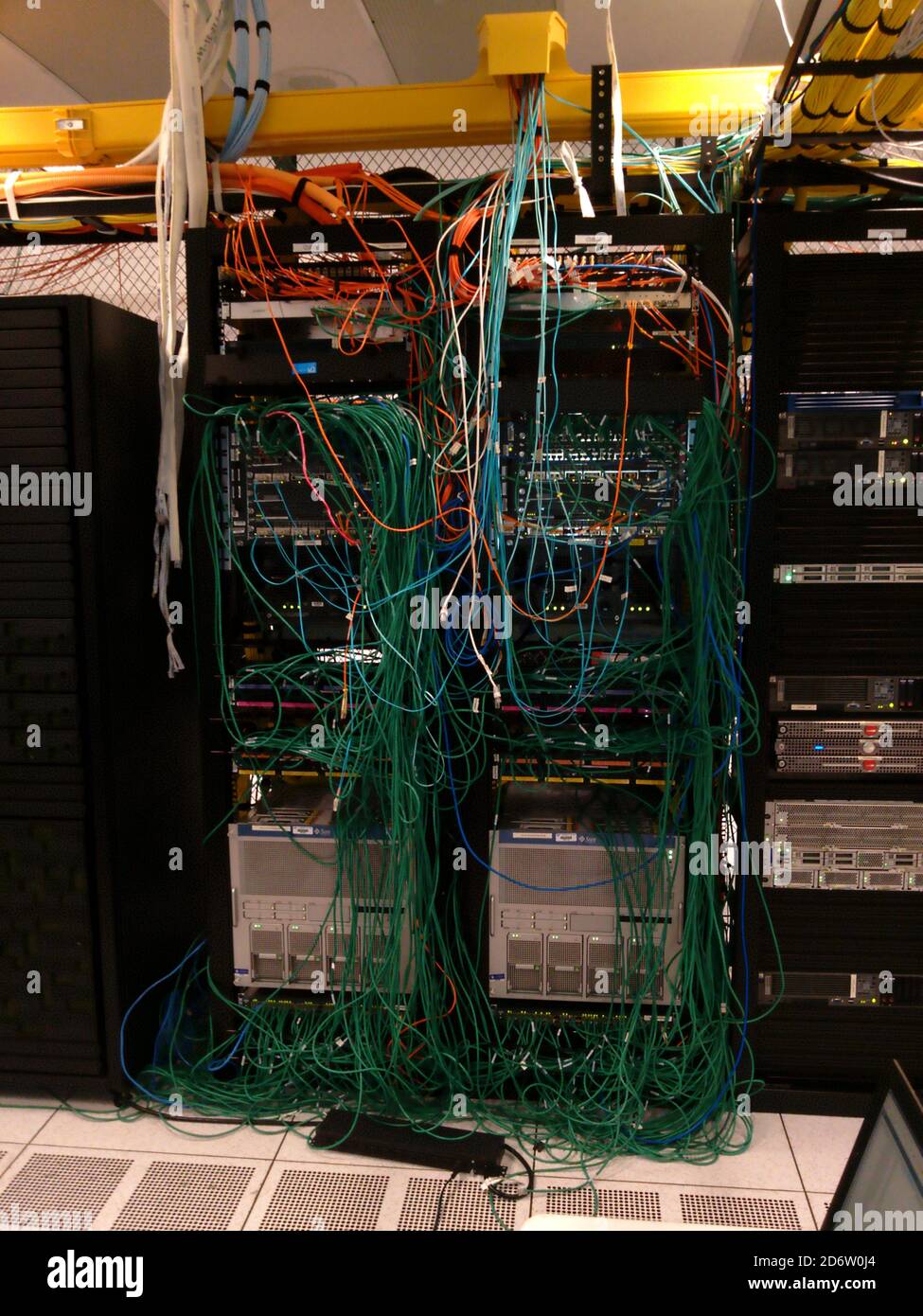 Network Spaghetti - An example of bad network cable management Stock Photo