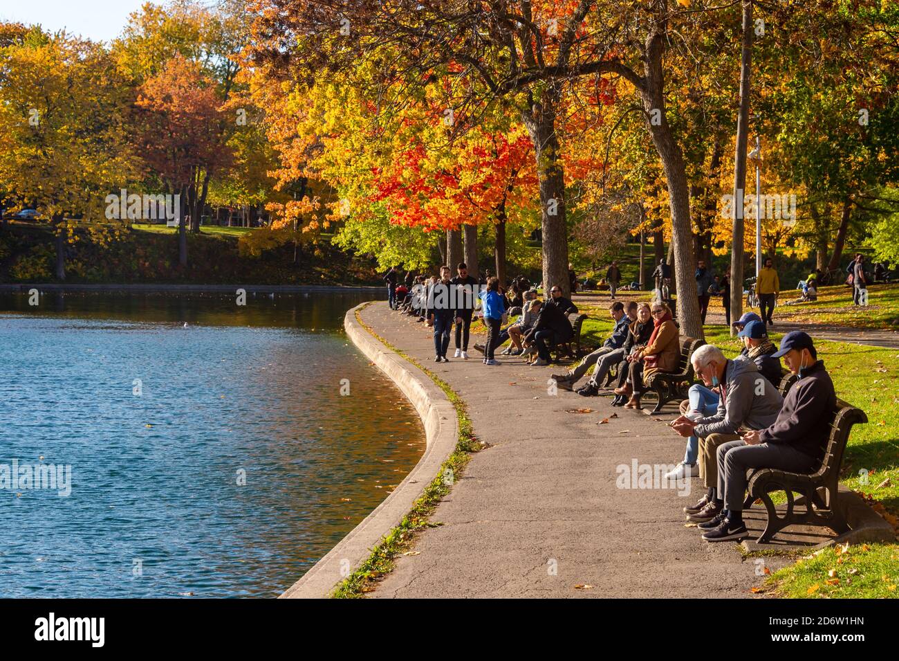 Montreal, CA - 19 October 2020: People enjoying a warm and sunny day at La Fontaine Park in the Autumn season Stock Photo