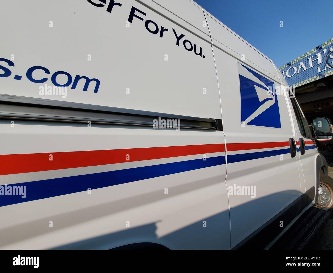 Wide angle view of United States Postal Service (USPS) truck with logo