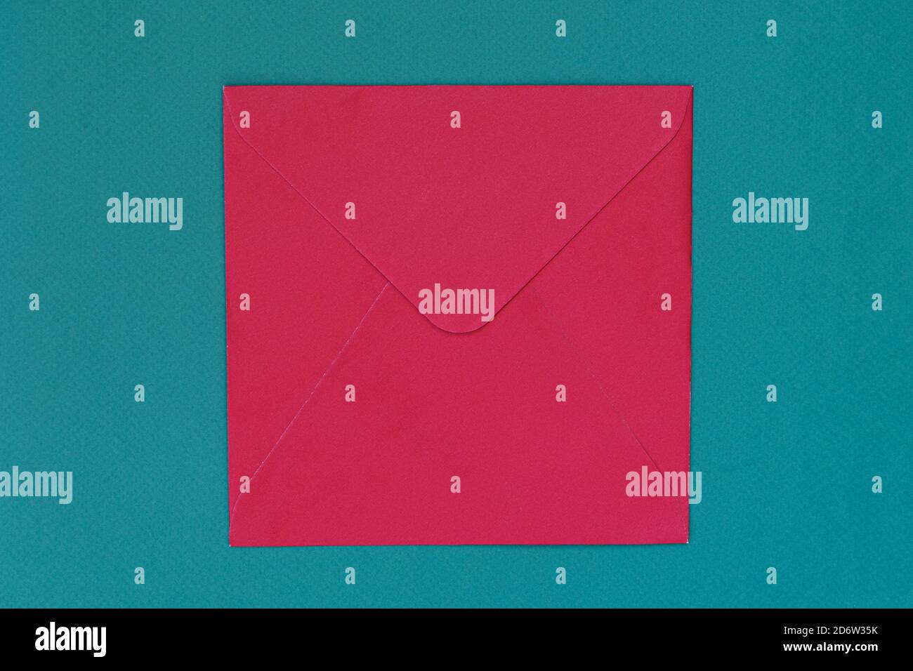 Red envelope to send letters on blue background. Concept of postal