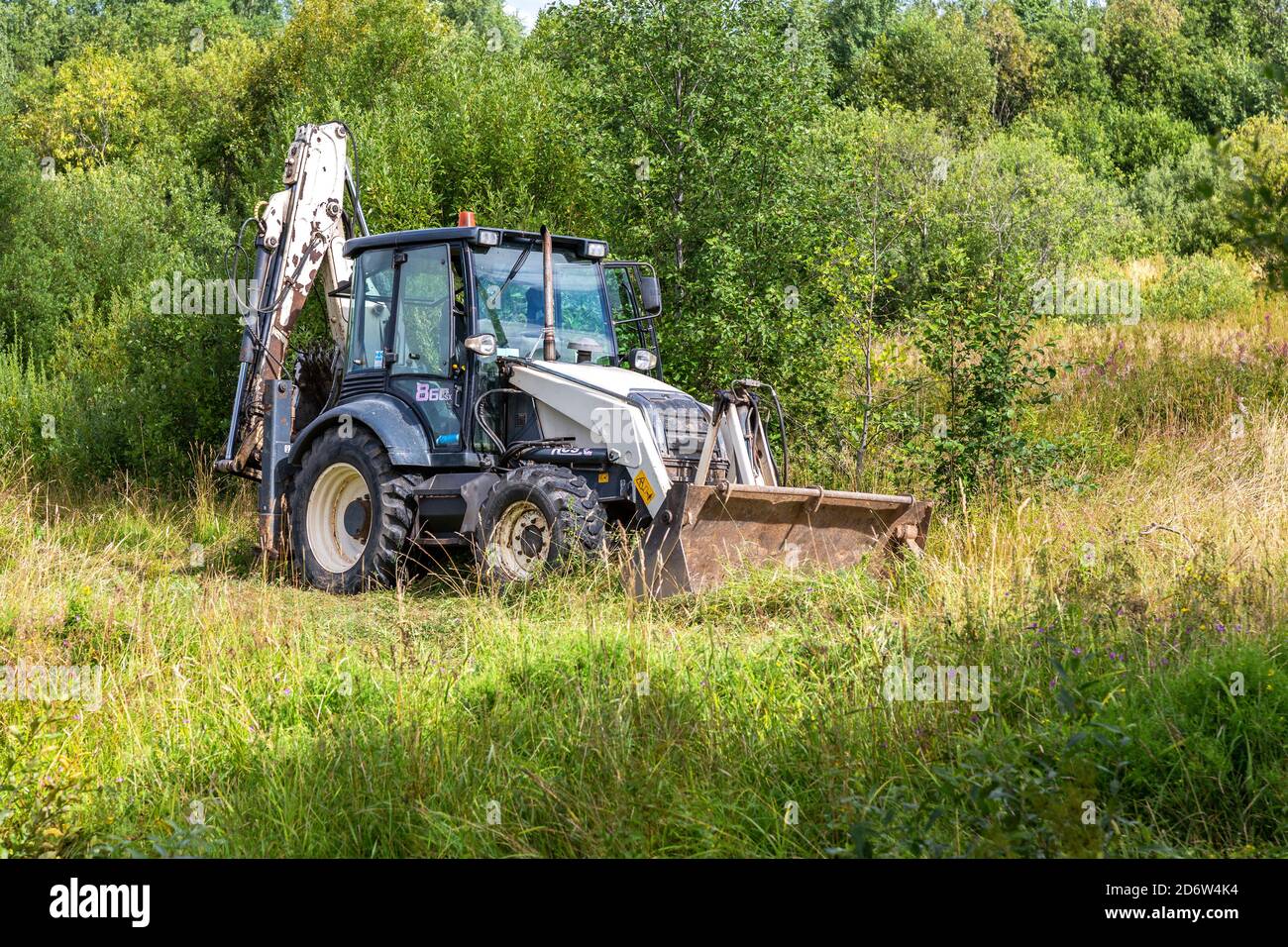 Novgorod, Russia - August 14, 2020: Bulldozer working at the countryside in summer day Stock Photo