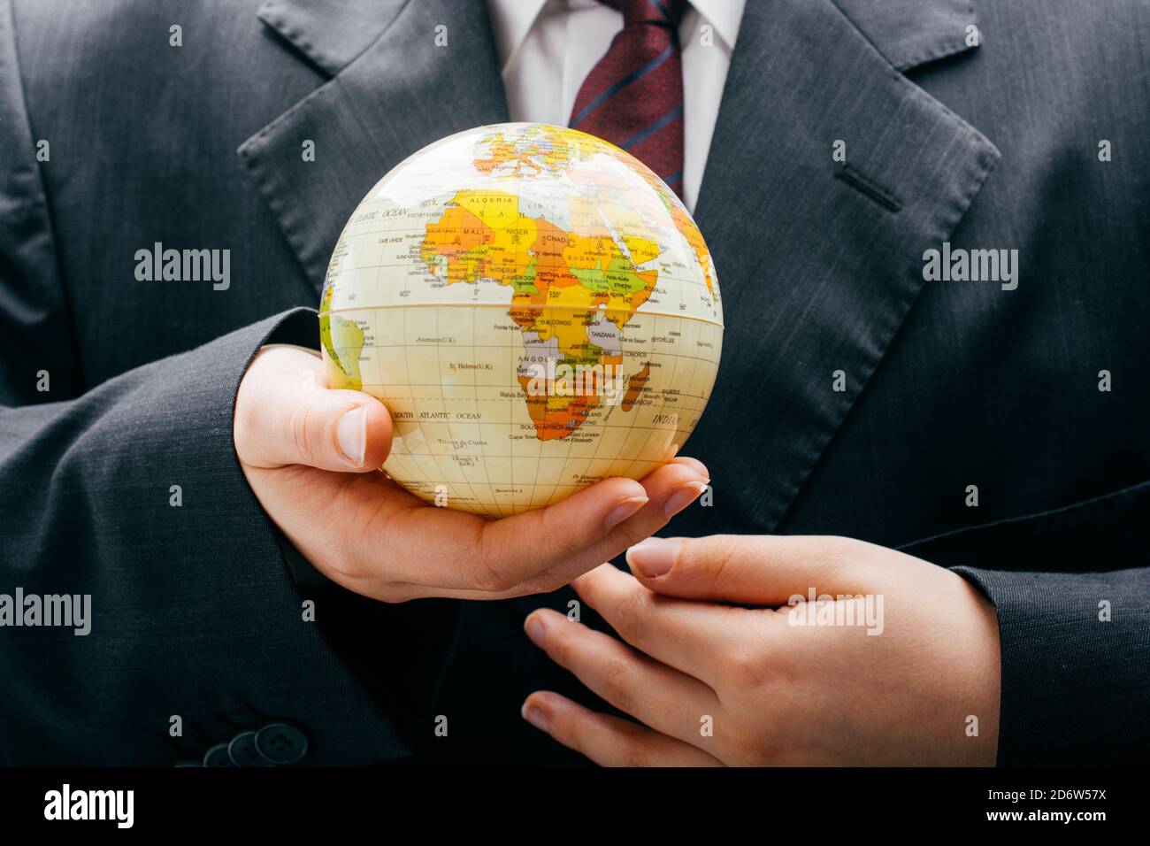 Businessman is standing with an earth globe fot business concept Stock ...