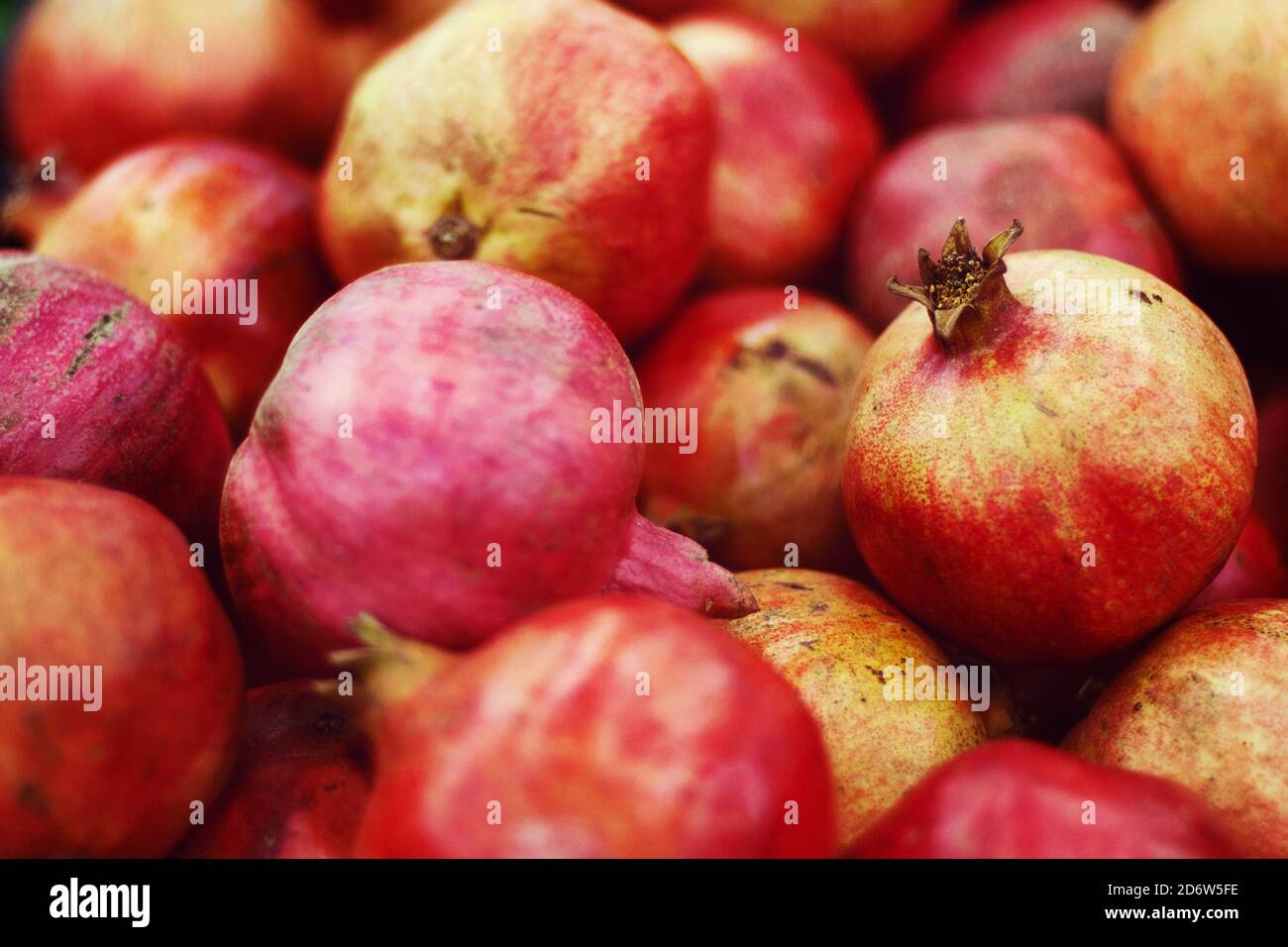 pile of pomegranates sold at fruit market, food background Stock Photo