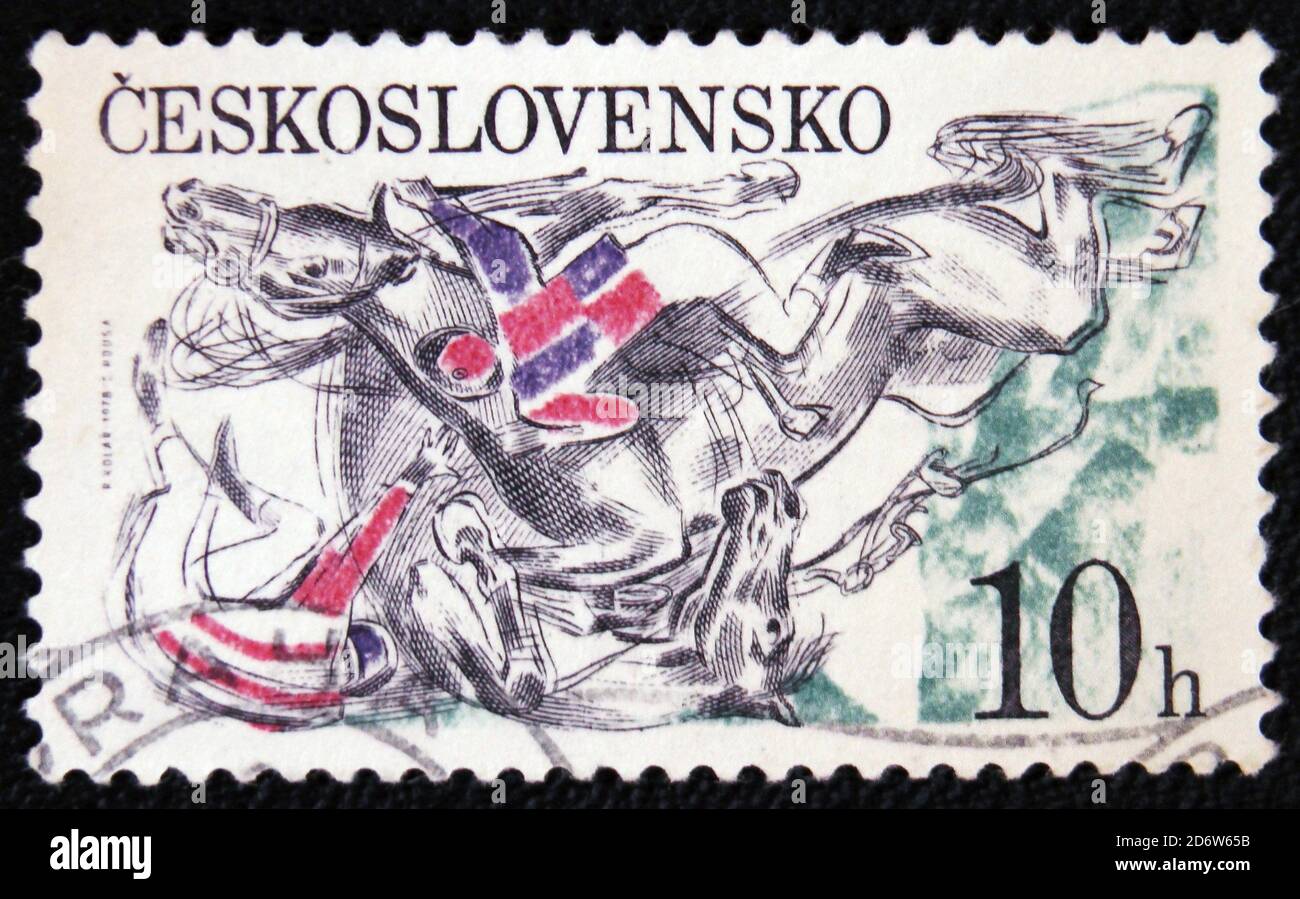 MOSCOW, RUSSIA - JANUARY 7, 2017: A stamp printed in the Czechoslovakia, Pardubice Steeplechase, shown Falling horses and jockeys at fence, circa 1978 Stock Photo
