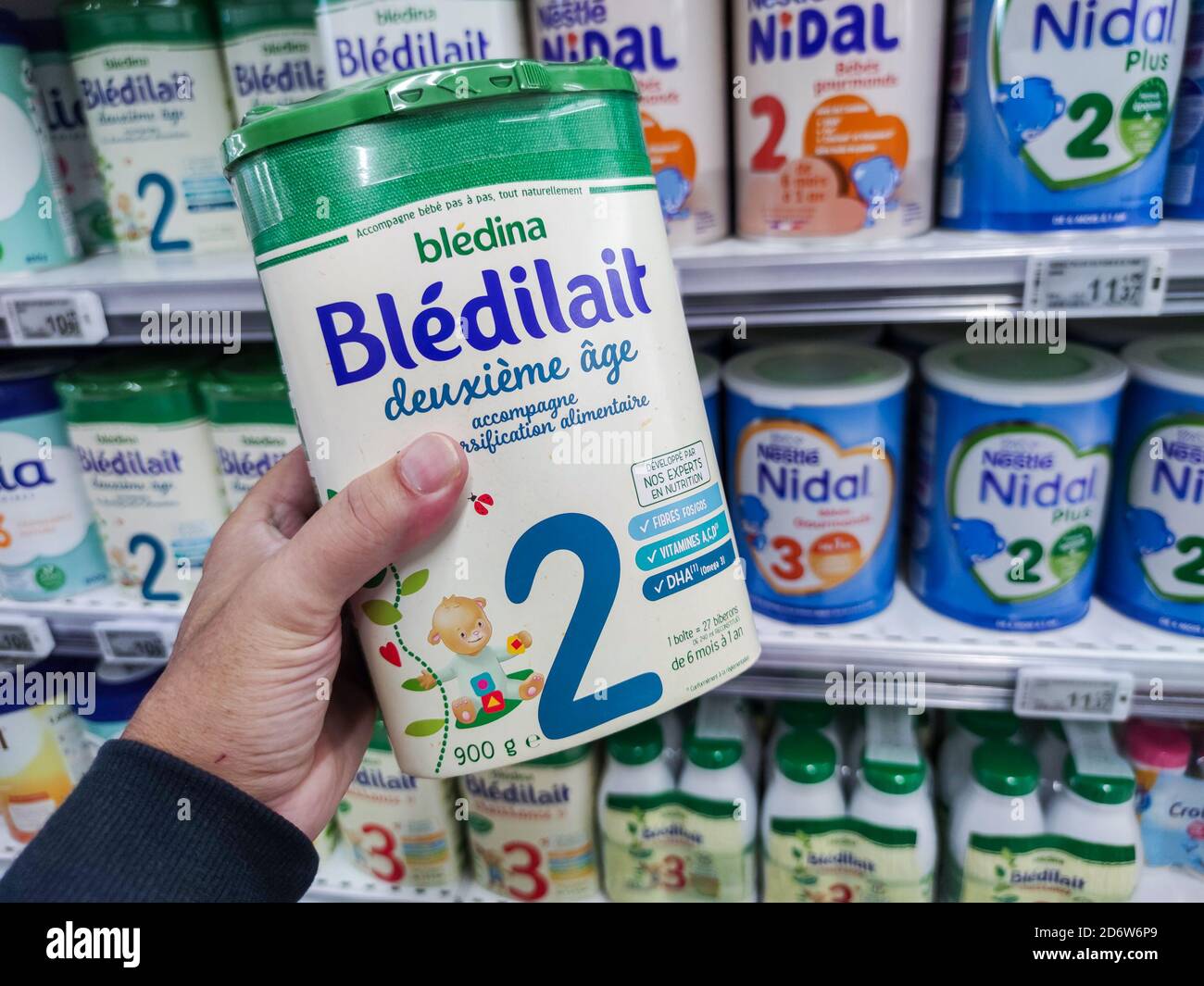 A Consumer Chooses a Box of Bledilait Brand Baby Milk from the