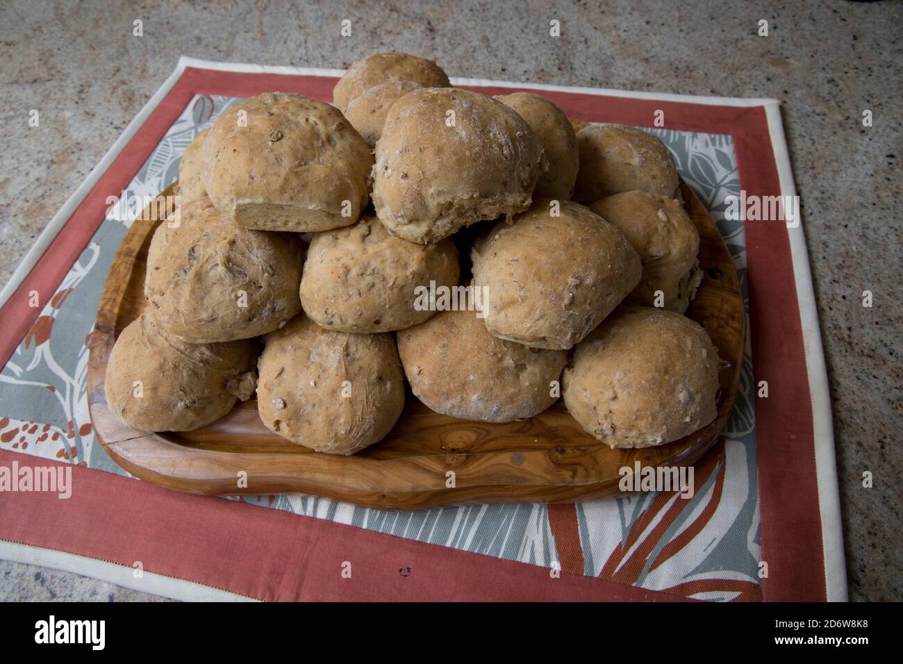 Batch of freshly baked crusty bread rolls UK Stock Photo