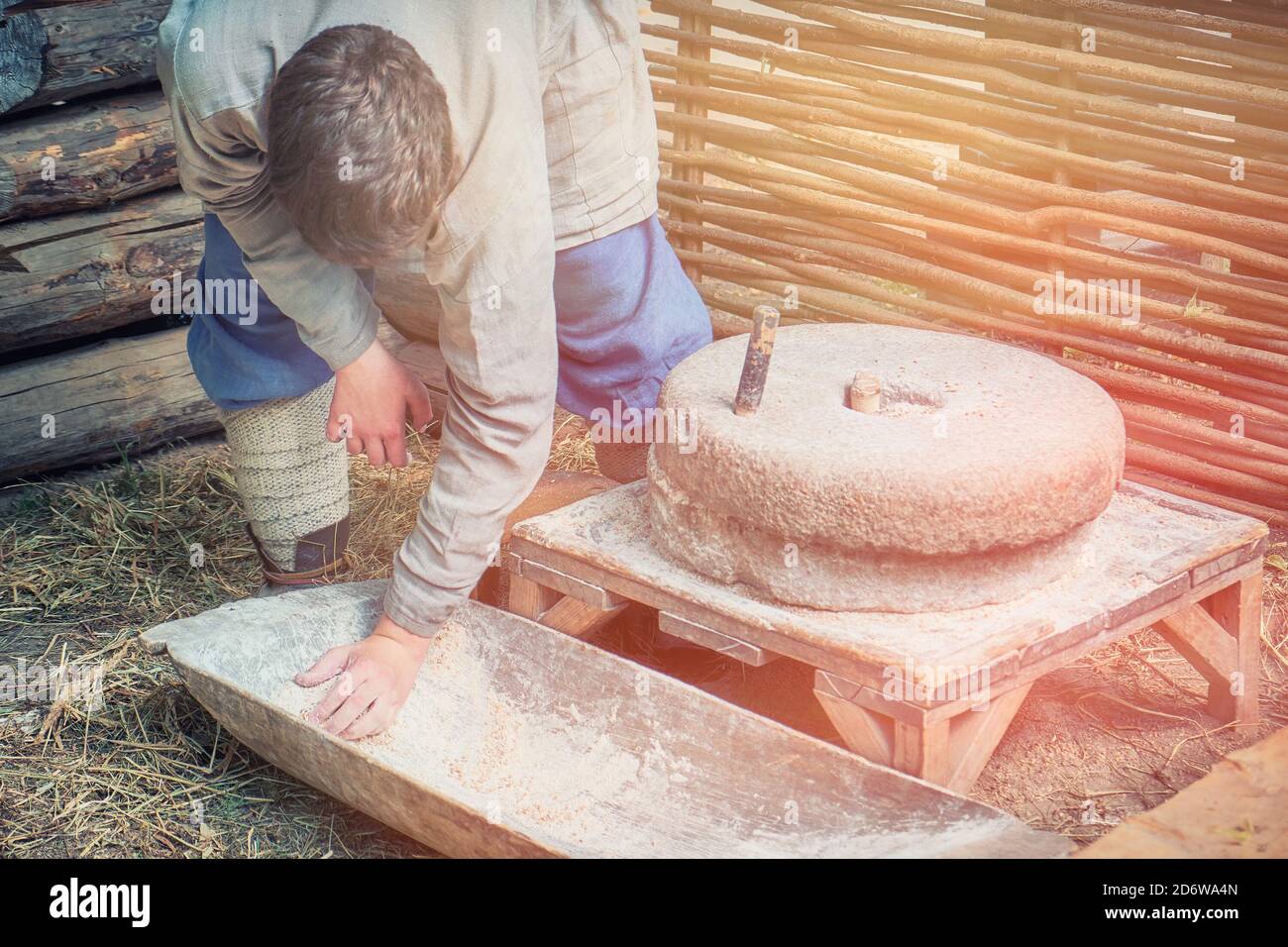 Man to grind flour on the hand mills. Rustic life for the production of
