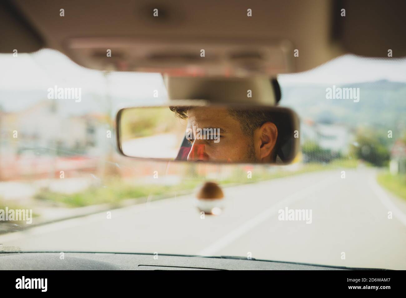 View of a man on the rearview mirror of a car Stock Photo - Alamy