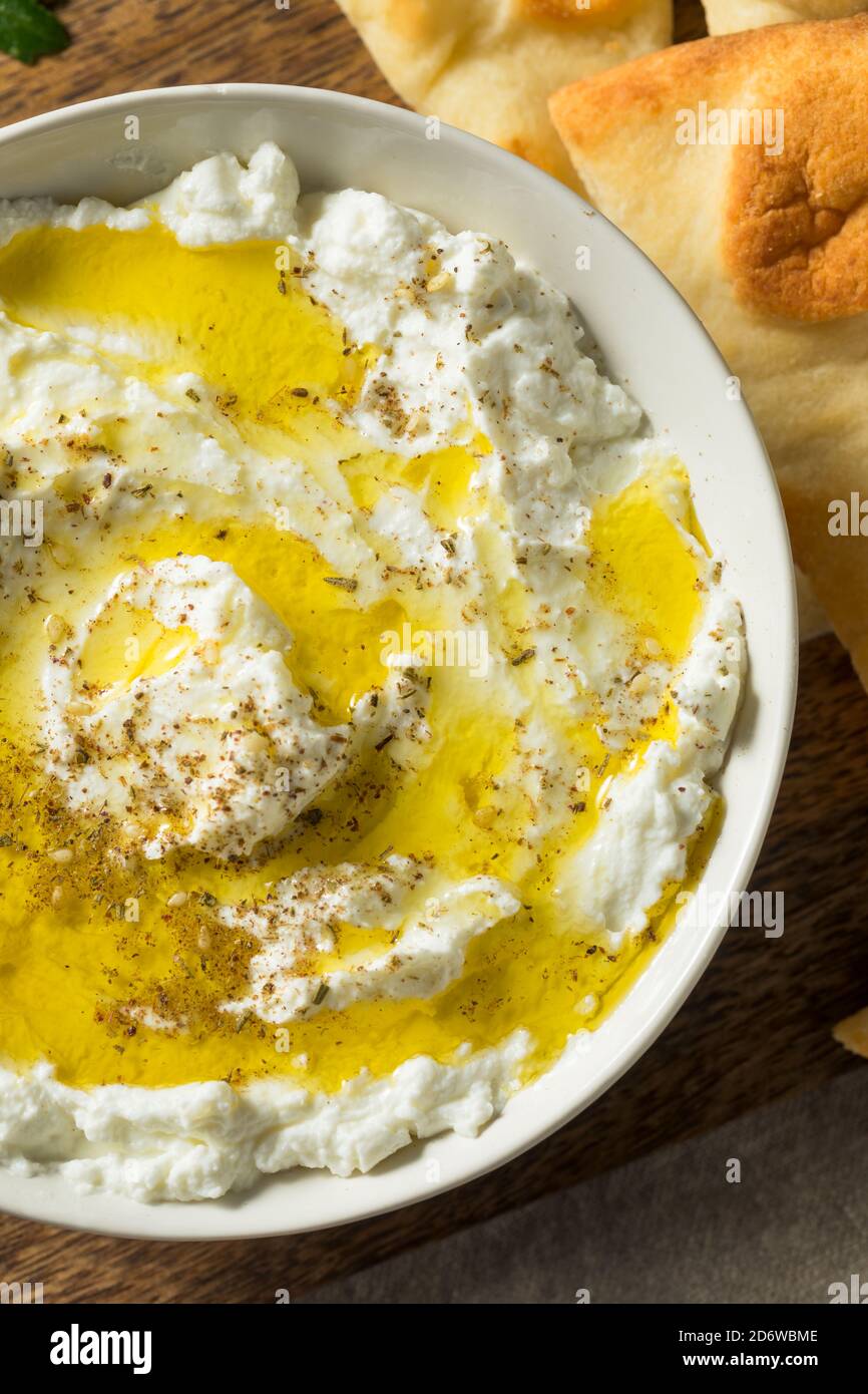 Homemade Yogurt Labneh Cheese Dip with Olive Oil and Pita Stock Photo