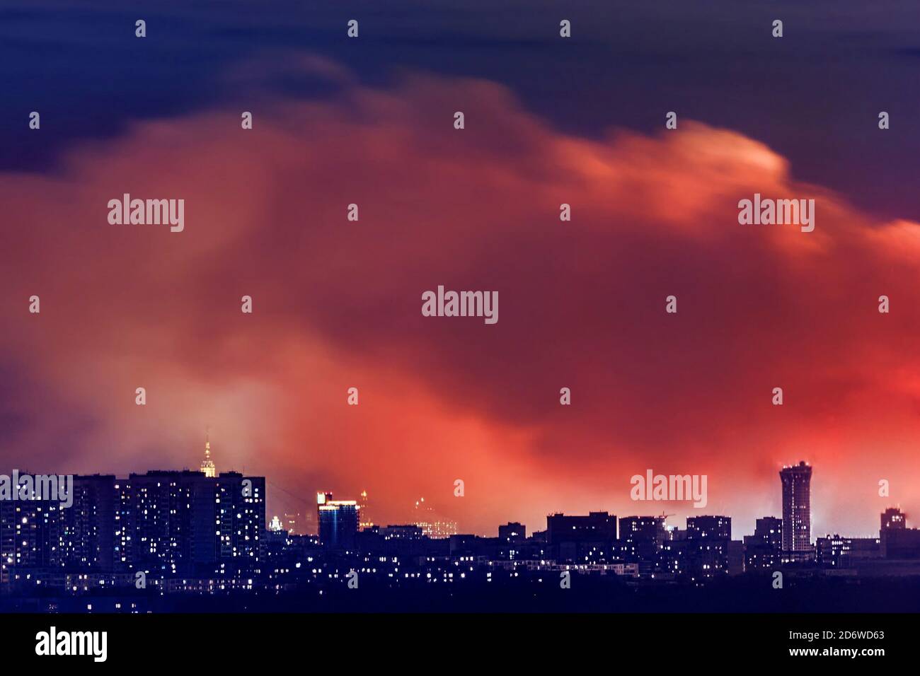 Smoke and fire in residential area in Moscow city at night Stock Photo