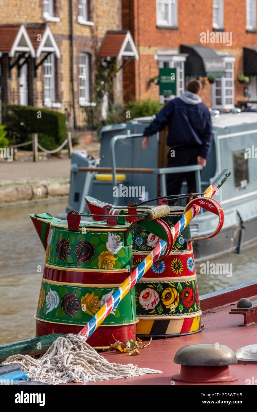 man at the helm or tiller of a traditional canal narrow boat ot barge on the grand union canal