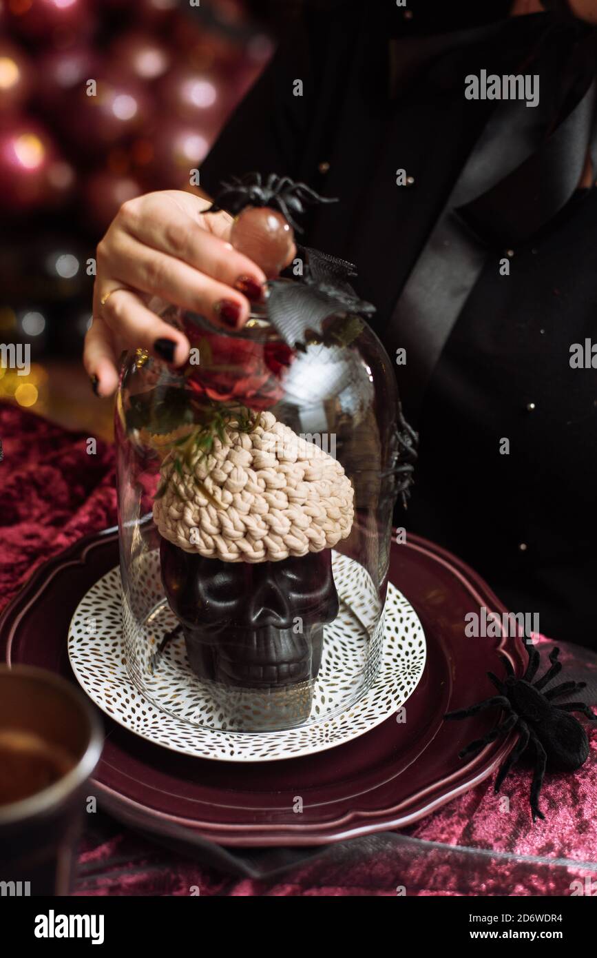 Artificial skull with knitted brains. Halloween decorations. Stock Photo