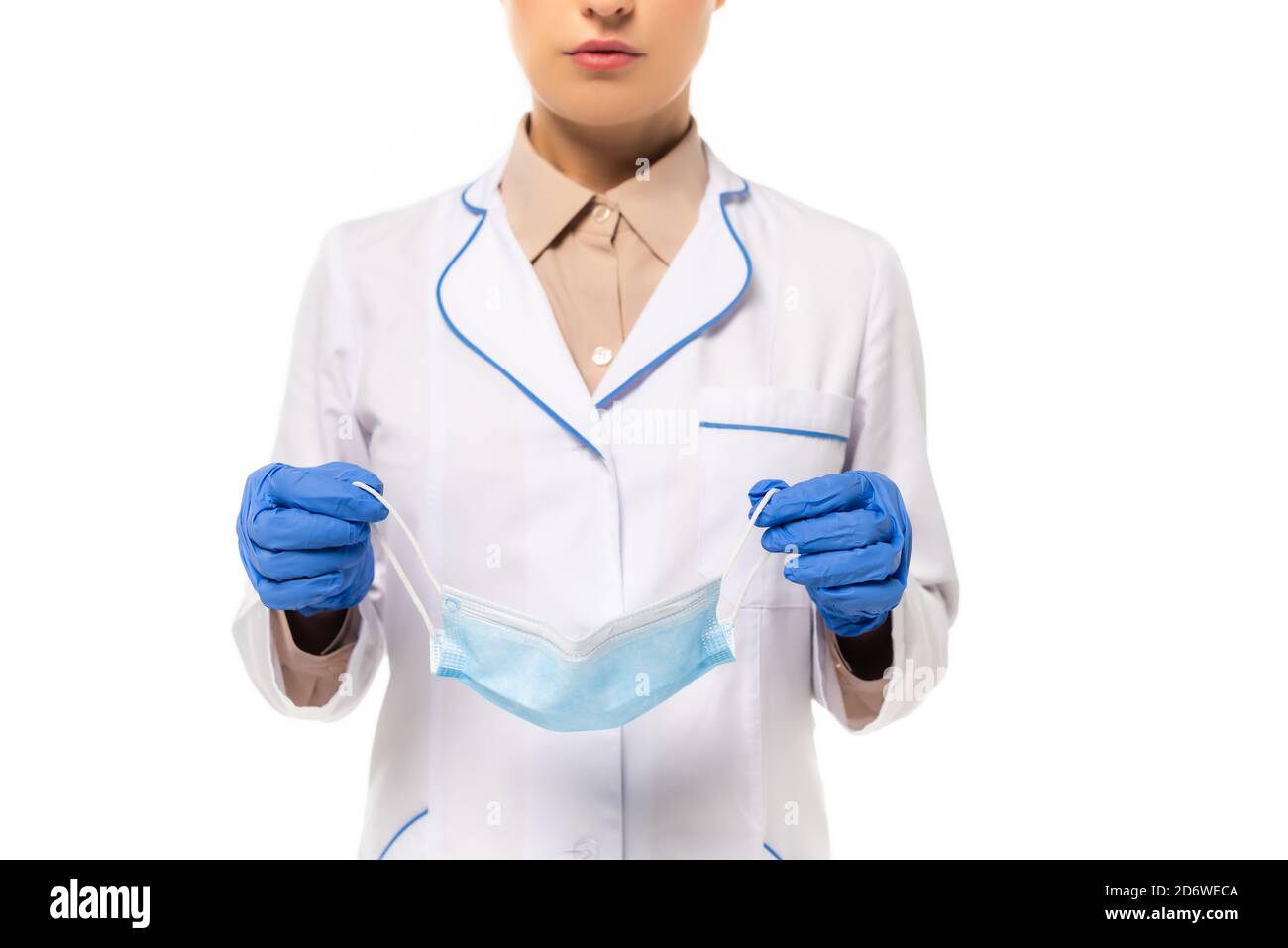 Cropped view of doctor in latex gloves holding medical mask isolated on ...
