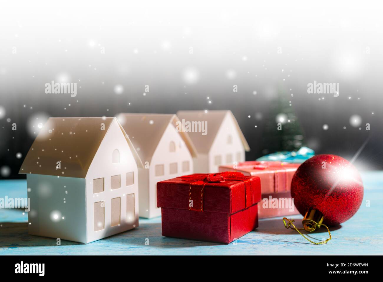 Christmas snowfall in a small village. Christmas gift boxes Stock Photo ...