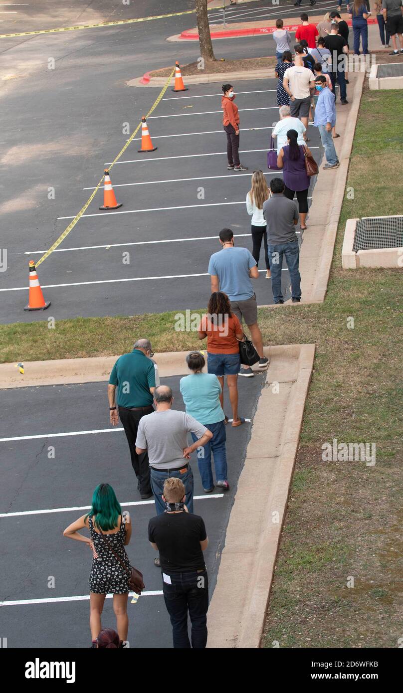 Austin, Texas USA, Oct. 13 2020: Masked-up Texans wait patiently in line at the Arboretum area of north Austin at an early voting site to cast ballots in the 2020 presidential election. Officials are reporting record numbers of early voters with almost 40,000 per day citywide. Stock Photo